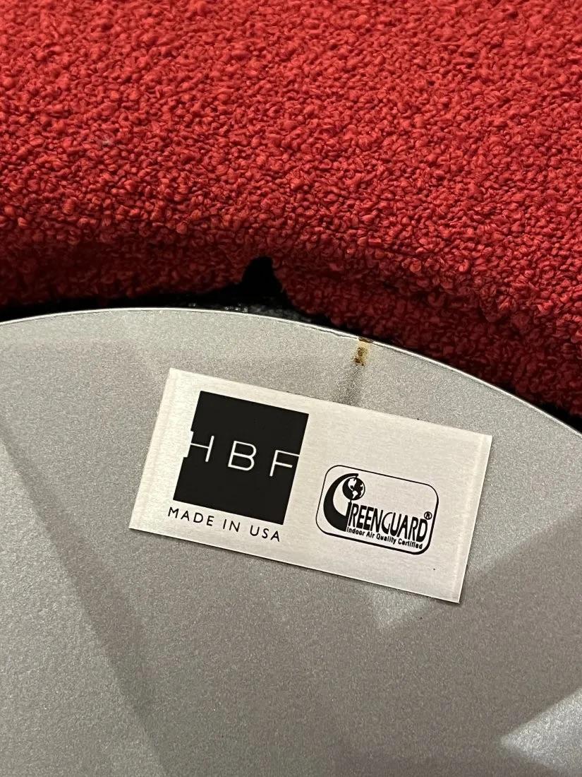 two red mid century lounge chairs in good condition

Designed by HBF 