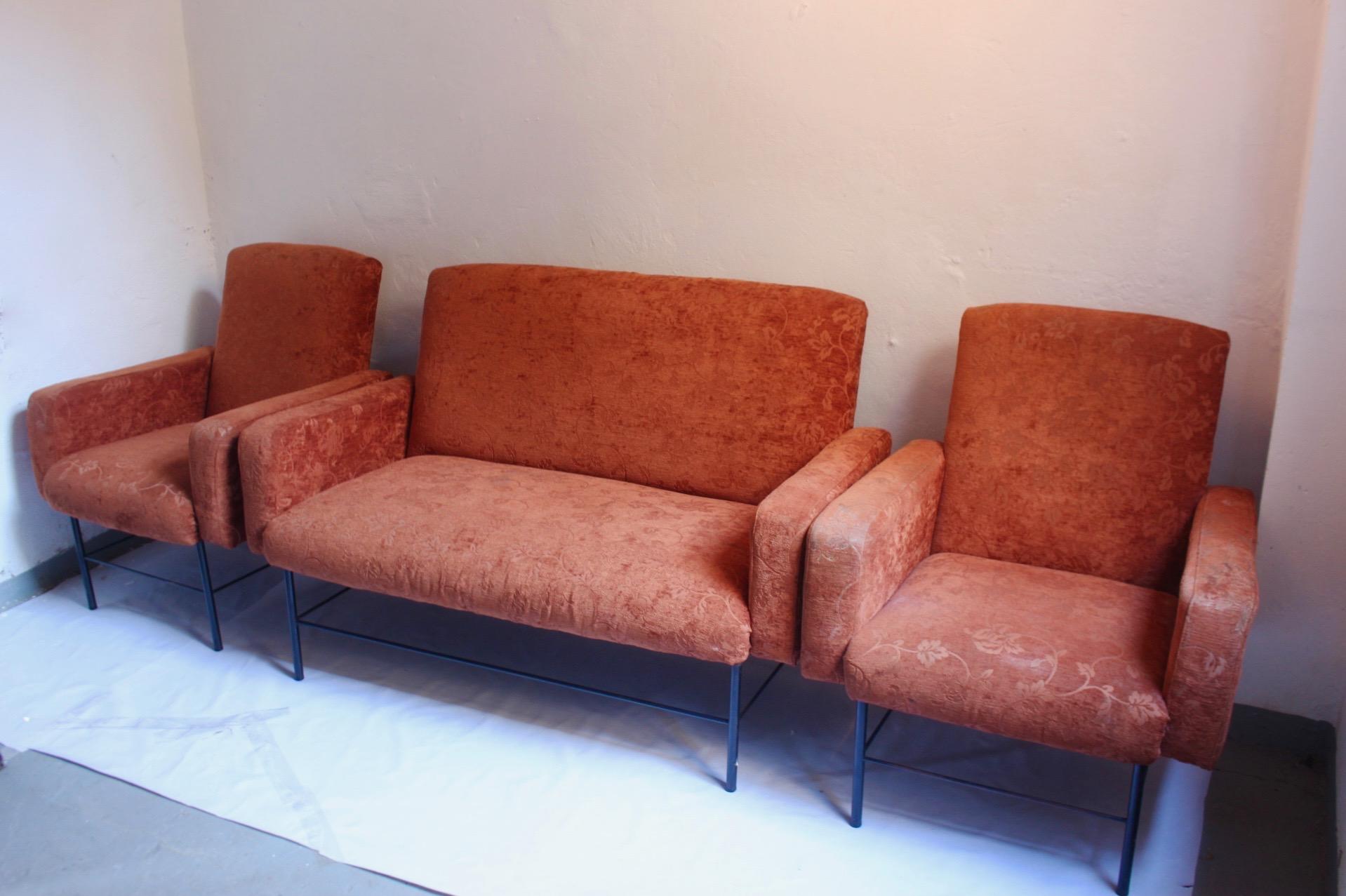 Midcentury rationalist living room lounge armchair set with metal legs, designed and produced in Spain, circa 1960s. The set is composed for 3 pieces. Two armchairs and one sofa. The set remains in good condition, featuring visible wear(some stains)