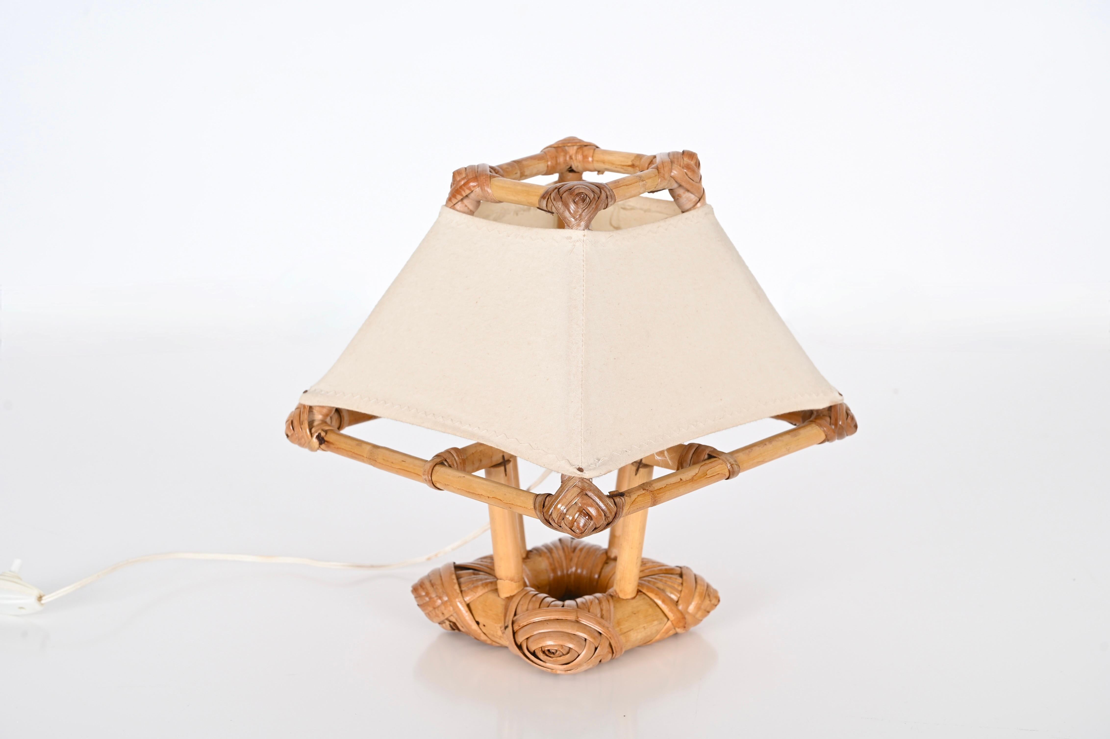 Gorgeous midcentury table lamp in rattan, bamboo and fabric. This fantastic piece was made in France in the 1960s and is attributed to Louis Sognot.

The lamp is striking because it features a clear example of 1960s craftsmanship and design, with