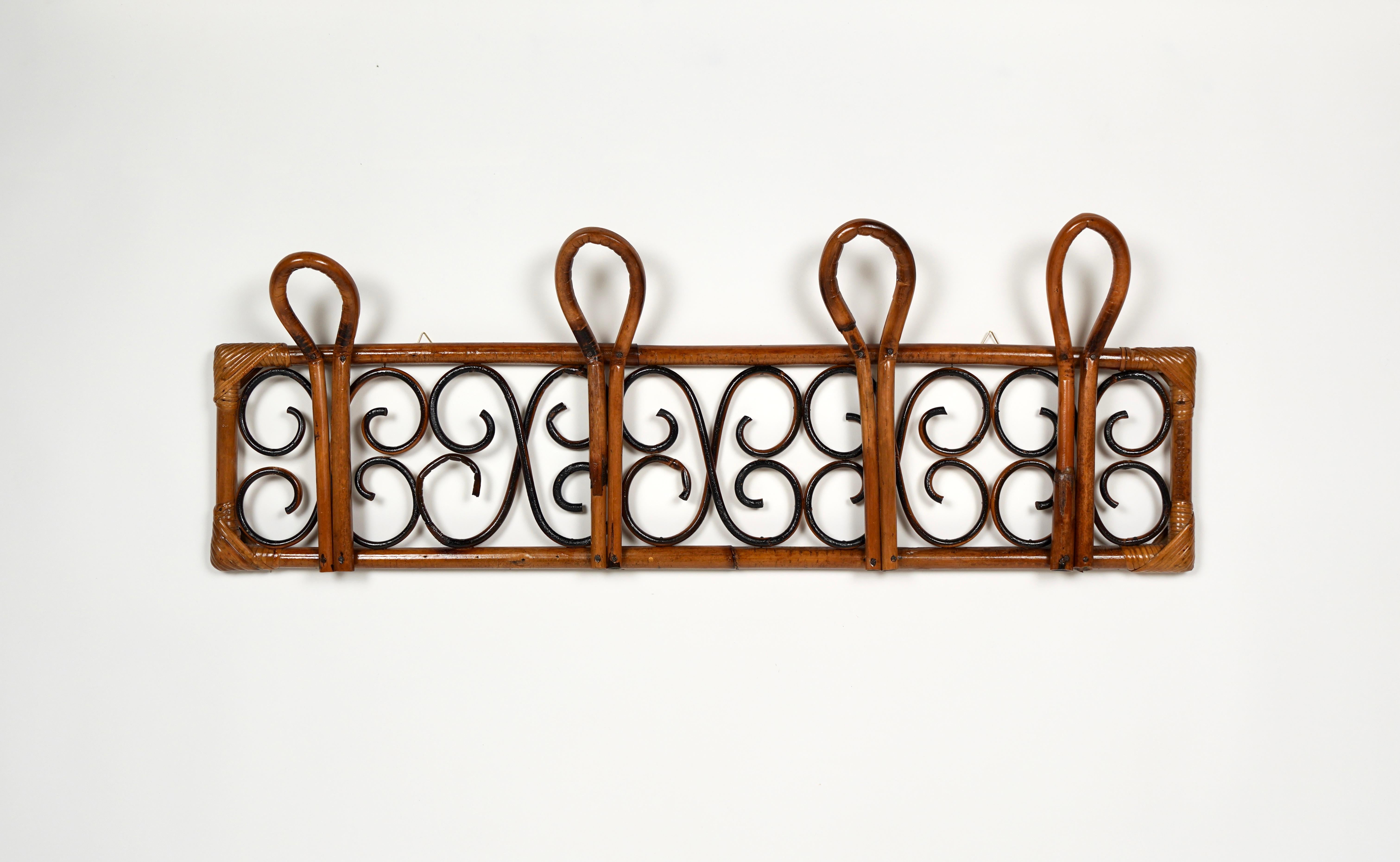 Midcentury coat rack stand in bamboo and rattan with four hooks. 

Made in Italy in the 1960s. 

The rattan material provides an easygoing chic, which flatters any interior.

Bamboo / rattan has been polished by a professional restorer.