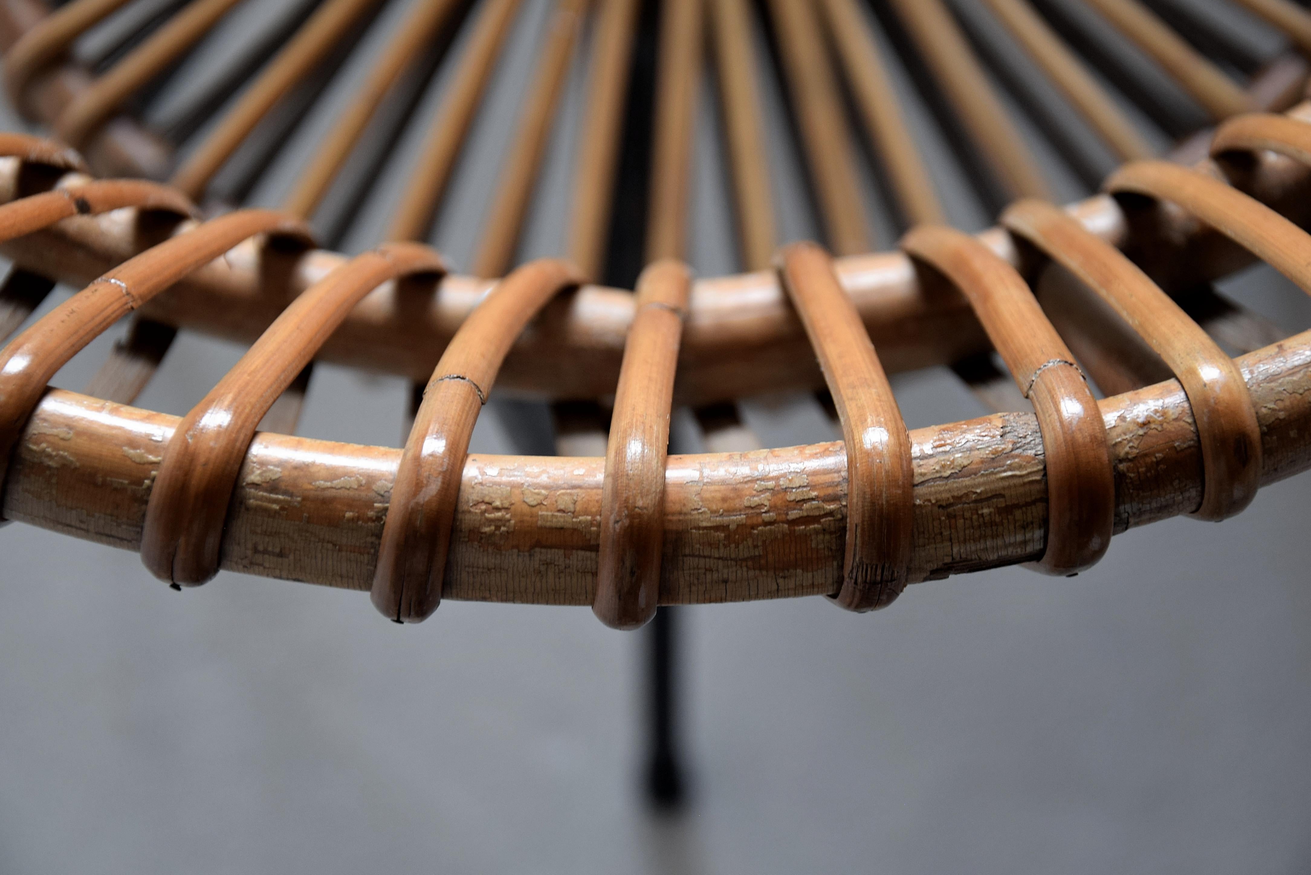 Stylish and elegant mid century black painted iron and rattan chair designed by Dirk van Sliedregt for the Gebroeders (brothers) Jonkers in the Netherlands. Dirk van Sliedregt (1920-2010) was a self made man who went from being a furniture maker to