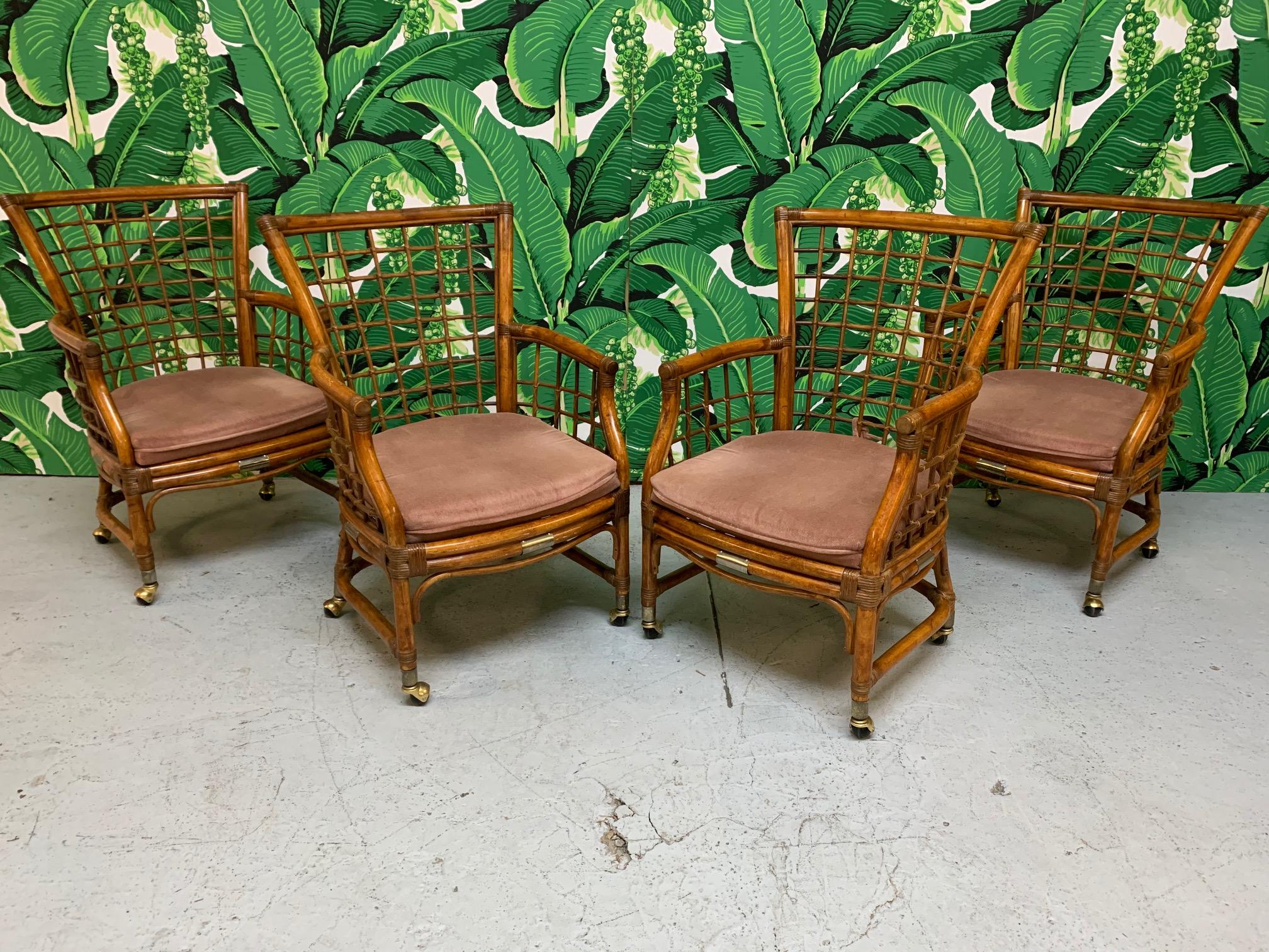 Midcentury rattan dining set features a rich, deep brown finish, brass accents, and a round glass top table. Chairs roll on original brass casters (can be removed). Very good vintage condition with minor imperfections consistent with age.
Table