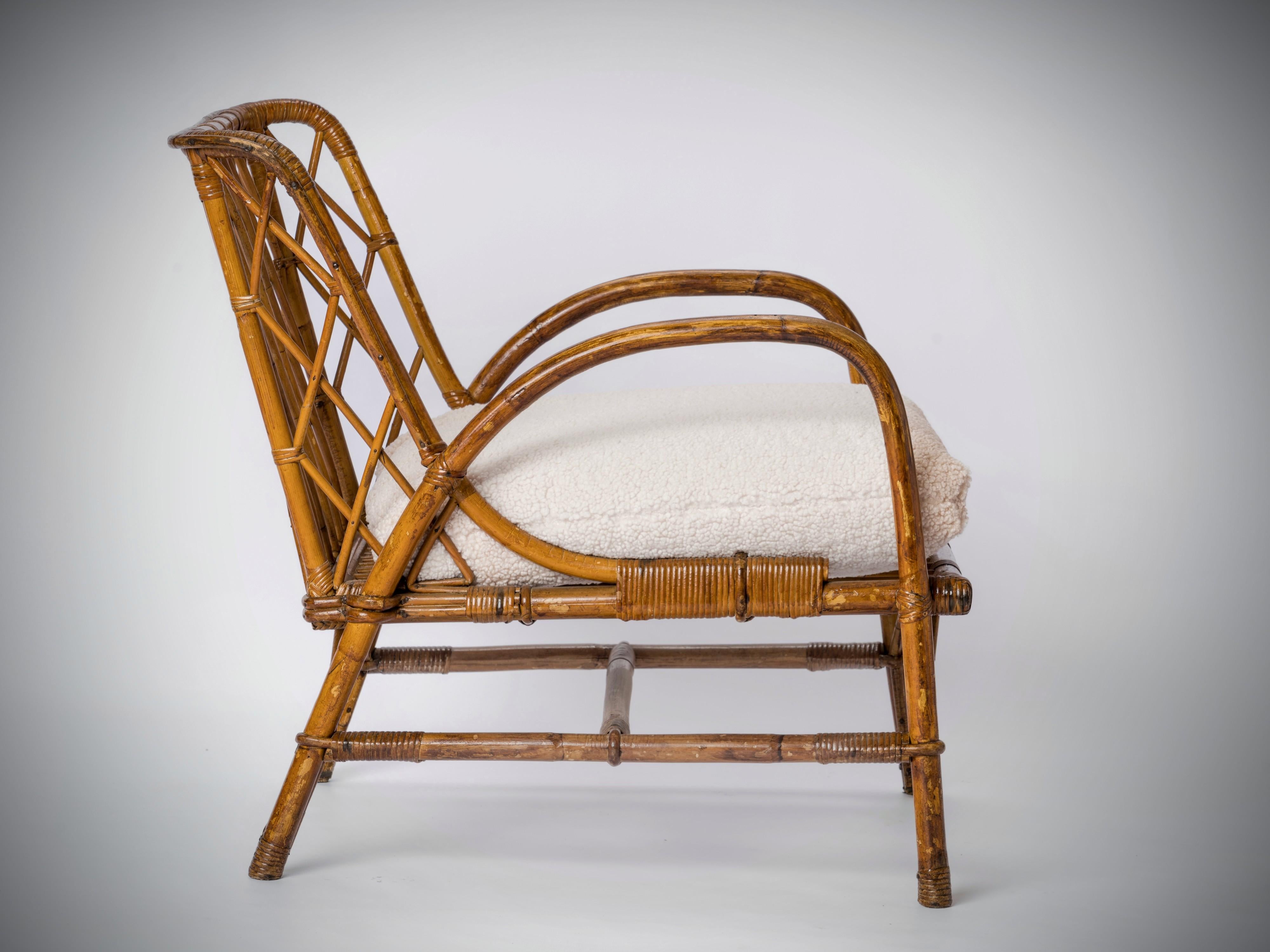 Basket shaped rattan lounger by Jacques Quinet for the city of Evian. Braided back rest structure. Lightly tinted rattan. In good vintage condition. 
Cushion for showing purposes. The chair sells without cushion but COM cushion can be made for an