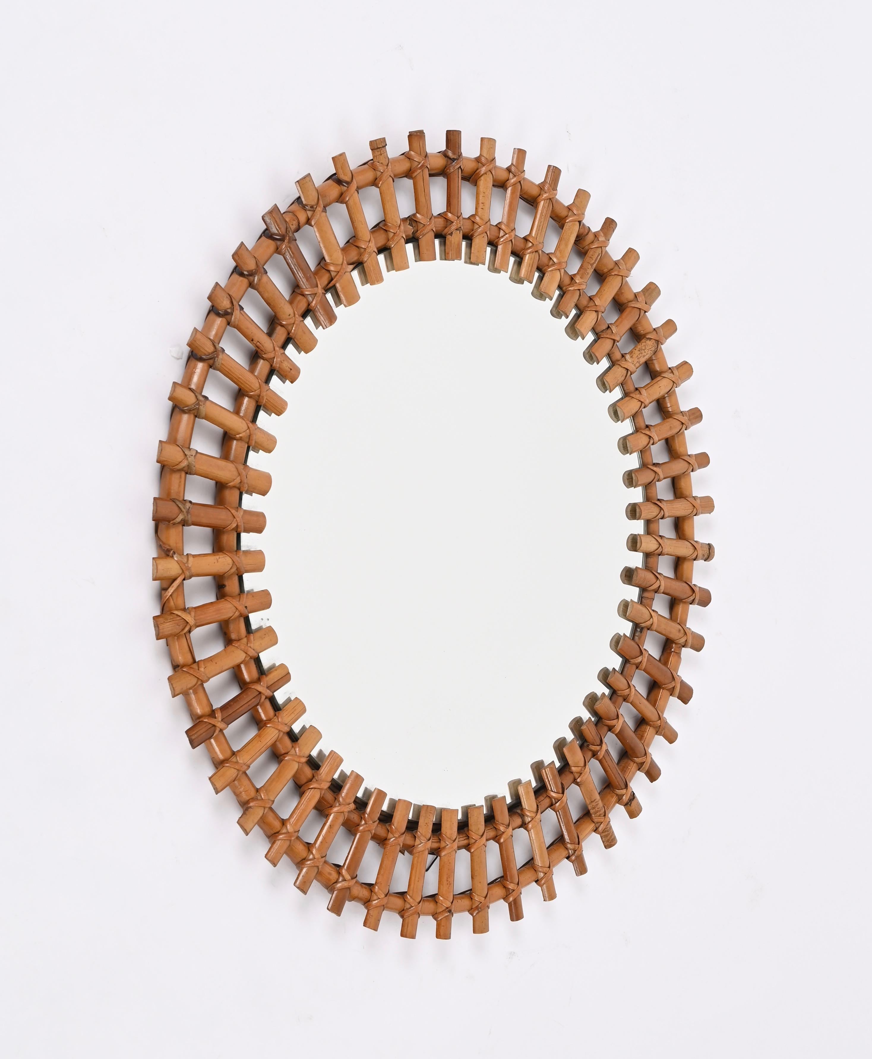 Spectacular mid-century French Riviera style round mirror in rattan, wicker and bamboo. This gorgeous piece was designed by Franco Albini and produced in in Italy during the 1970s.

This stunning mirror, fully hand-crafted with perfect proportions