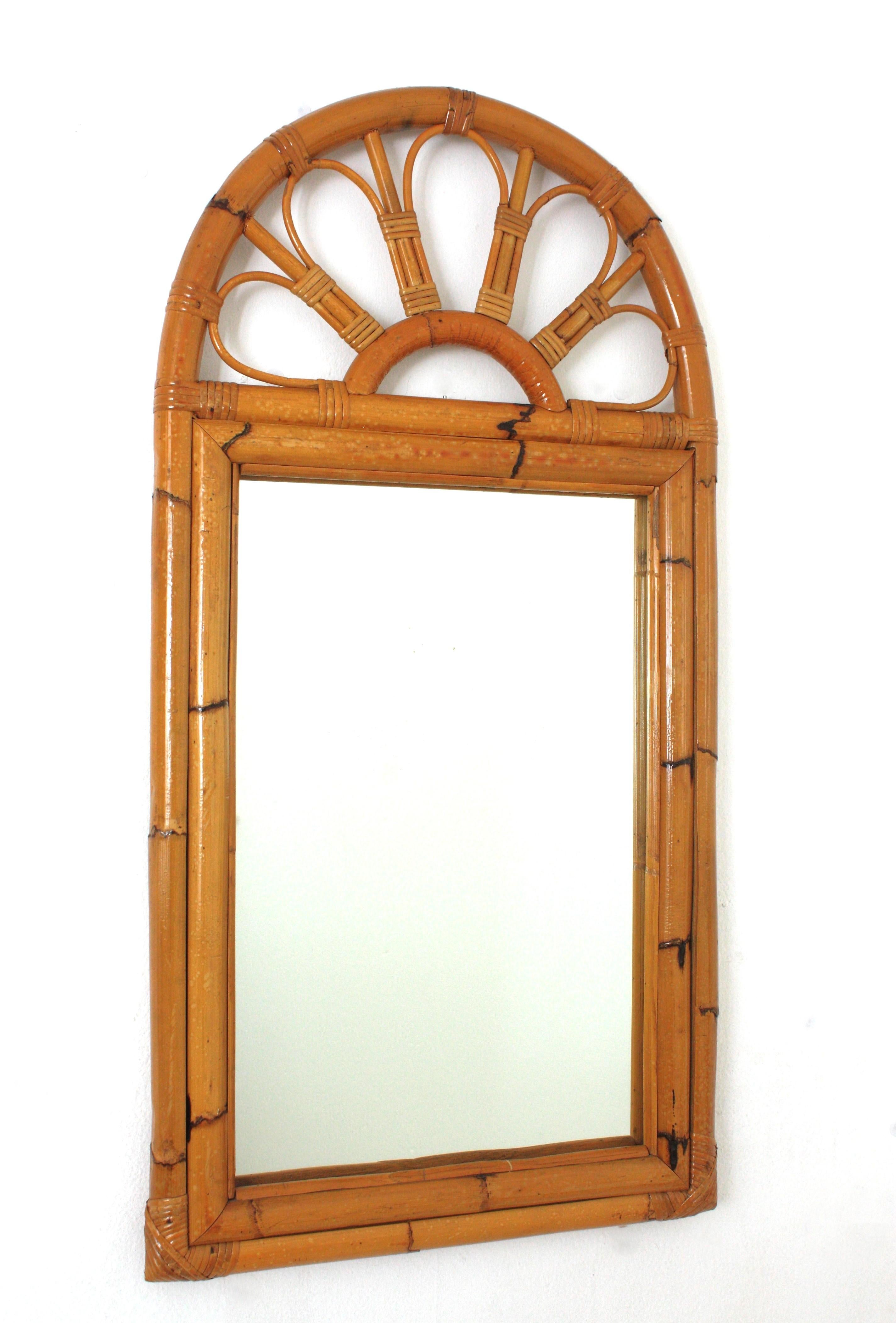 Eye-catching midcentury bamboo and rattan mirror with arched top. Spain, 1960s
This beautiful mirror was handcrafted with bamboo cane and rattan combining midcentury and tiki accents.
It will be a nice addition to be used in a bathroom or as wall