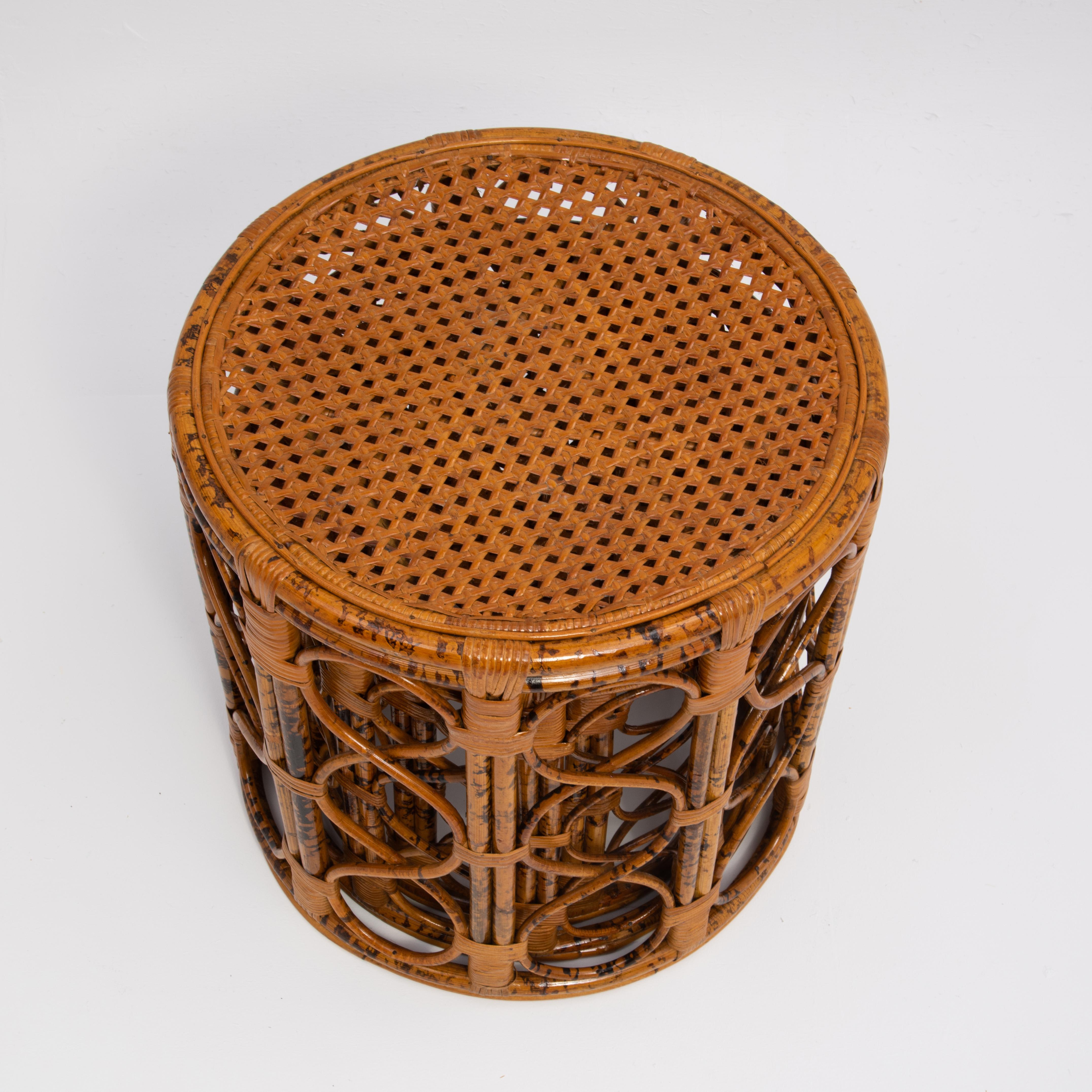 A set of three Mid Century rattan & bamboo nesting tables. Caned tops and tortoise shell, scorched or brunt bamboo frames. 1960s.

The largest is W 20