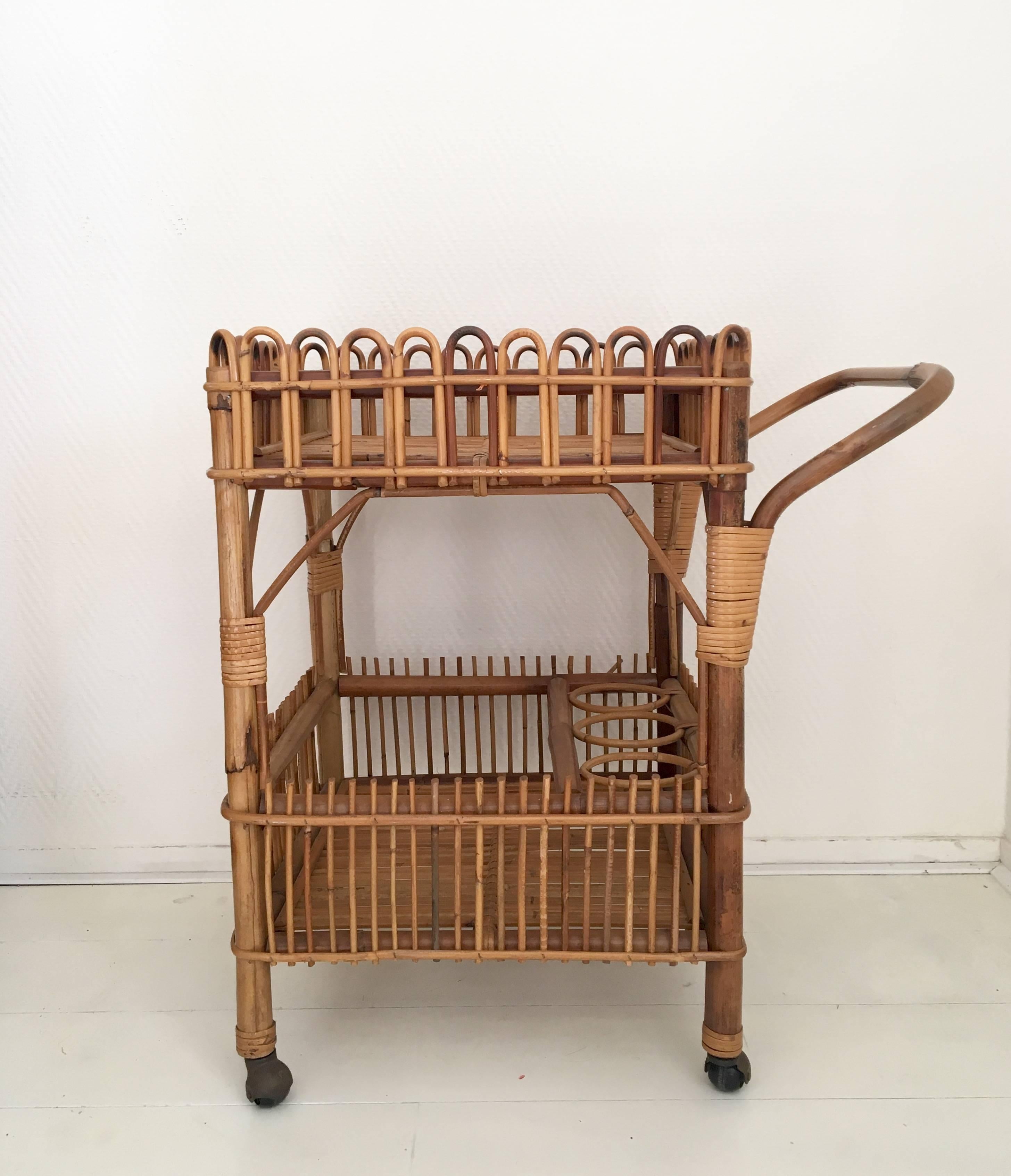 This unusual wonderful trolley was designed and manufactured in Europe, circa 1960s. It can store tree bottles and still offers enough space for other items. This trolley remains in very good condition for it's age. Some signs of age and use.