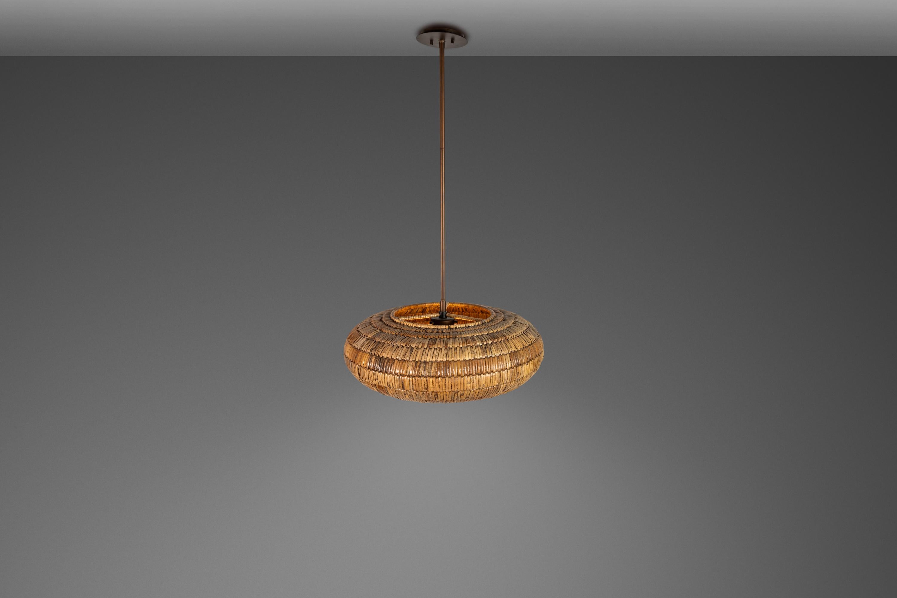 Introducing a rare, limited edition Organic Modern chandelier by the Breuer Collection for Troy Lighting. Featuring a hand-woven donut shape this elegant chandelier is constructed from sustainably-harvested Malacca palm strands that add a perfect