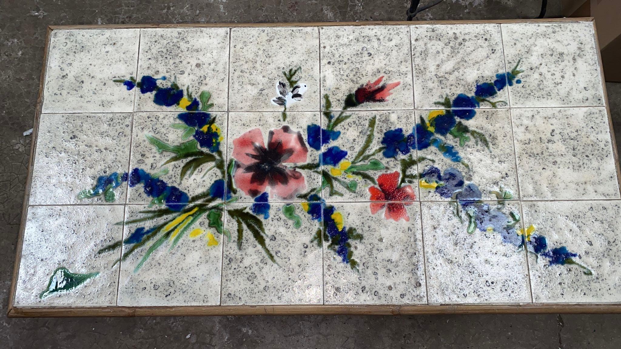 Rare Mid-Century Rattan & Ceramic Tiles Coffee Table Audoux Minet, Circa 1960.
Painting of wild flowers signed.
Height / 19 inches.
Size / 37 inches by 20.5 inches.

