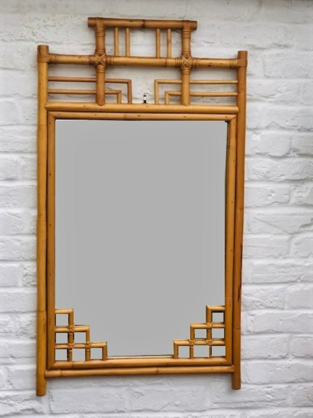 Mid Century Rattan Chinoiserie /Chinese Chippendale style rectangular wall mirror, Italian, 1970s 

A Fabulous Rattan Chinoiserie Tiki style rectangular wall mirror handcrafted with Rattan canes. It has a highly decorative frame with oriental