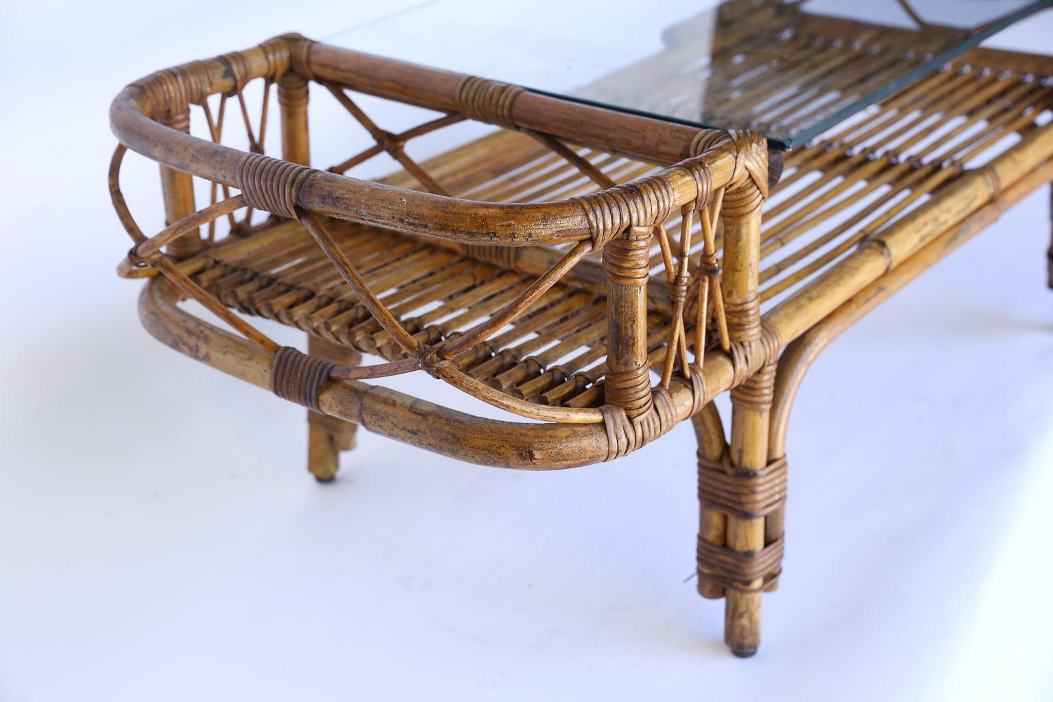 Found in France, this petite rattan coffee table is sure to add character and charm to your home. The piece has a bottom tier for storage or display with a 26.75