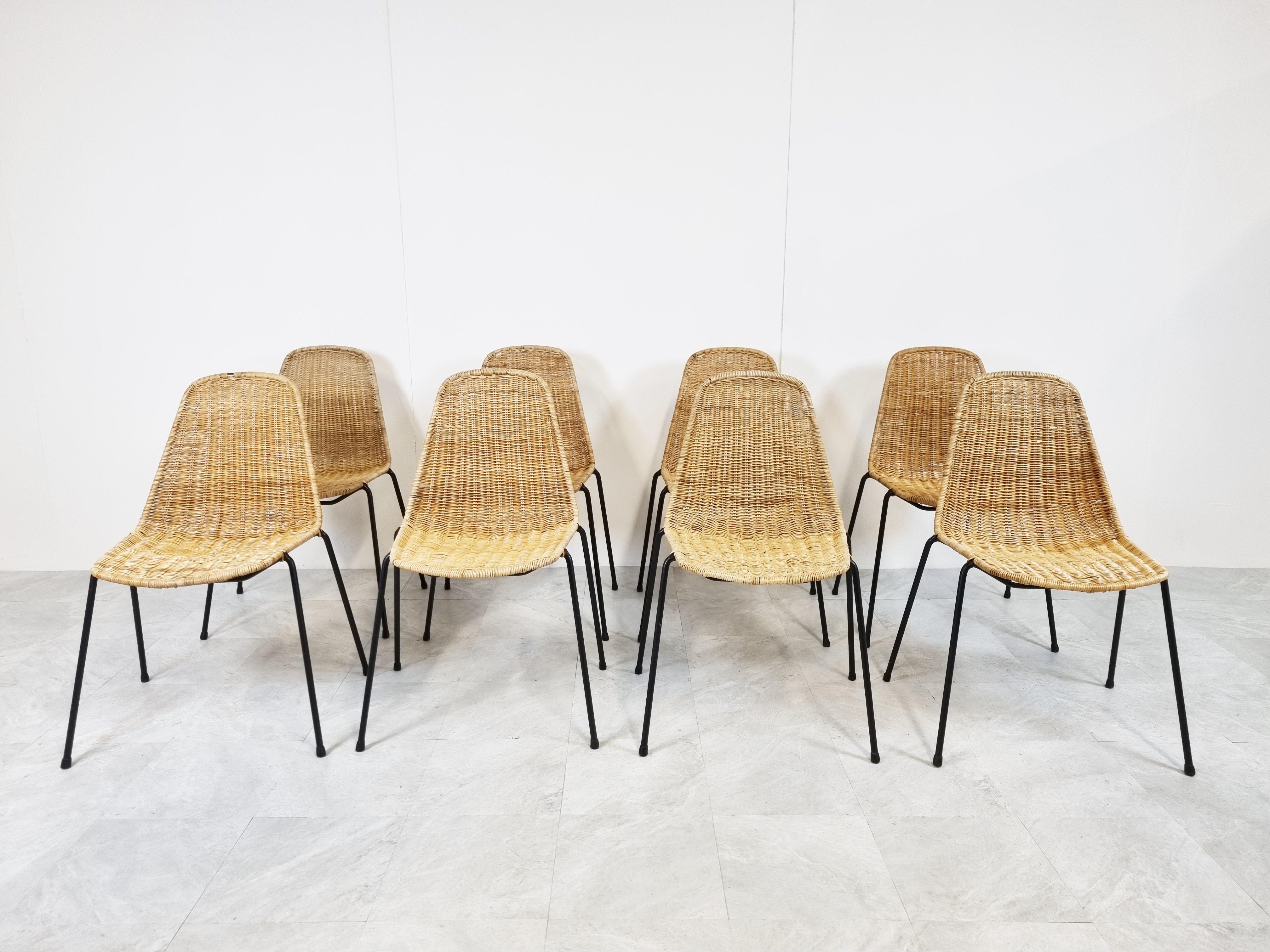 Elegant mid century stakable chairs made from Rattan mounted on a black metal base.

Timeless mid century design.

The chairs are in good condition

Switzerland - 1960s 

Dimensions: 
Height: 84cm/33.07