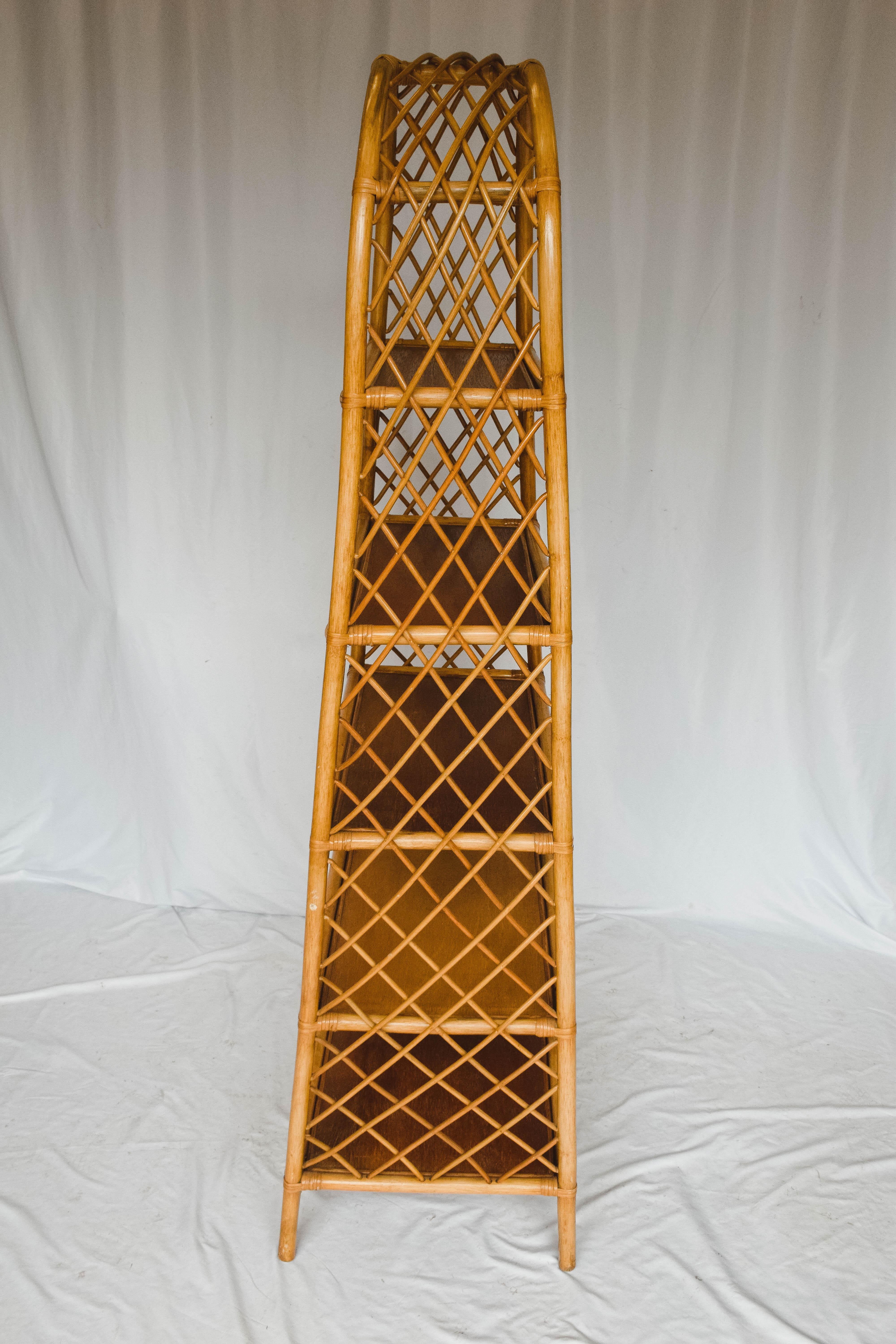 This 5 shelf midcentury rattan étagère features a lattice work detail around the sides and tapers up to a rounded top. This piece would make a statement in a bath or reading nook.