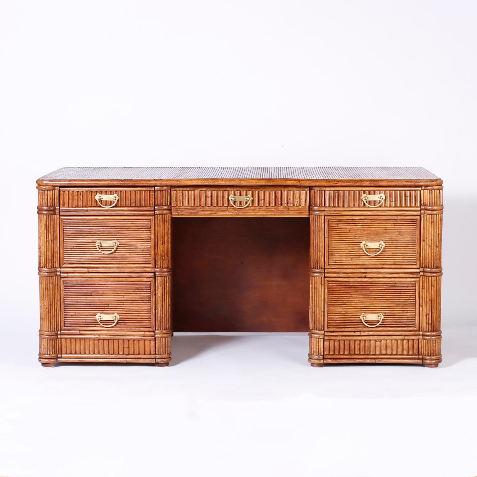 Seven drawer desk crafted in pencil reed featuring flowing wave patterns on the sides and back over a classic case, making this desk the perfect marriage of modern design and traditional form.