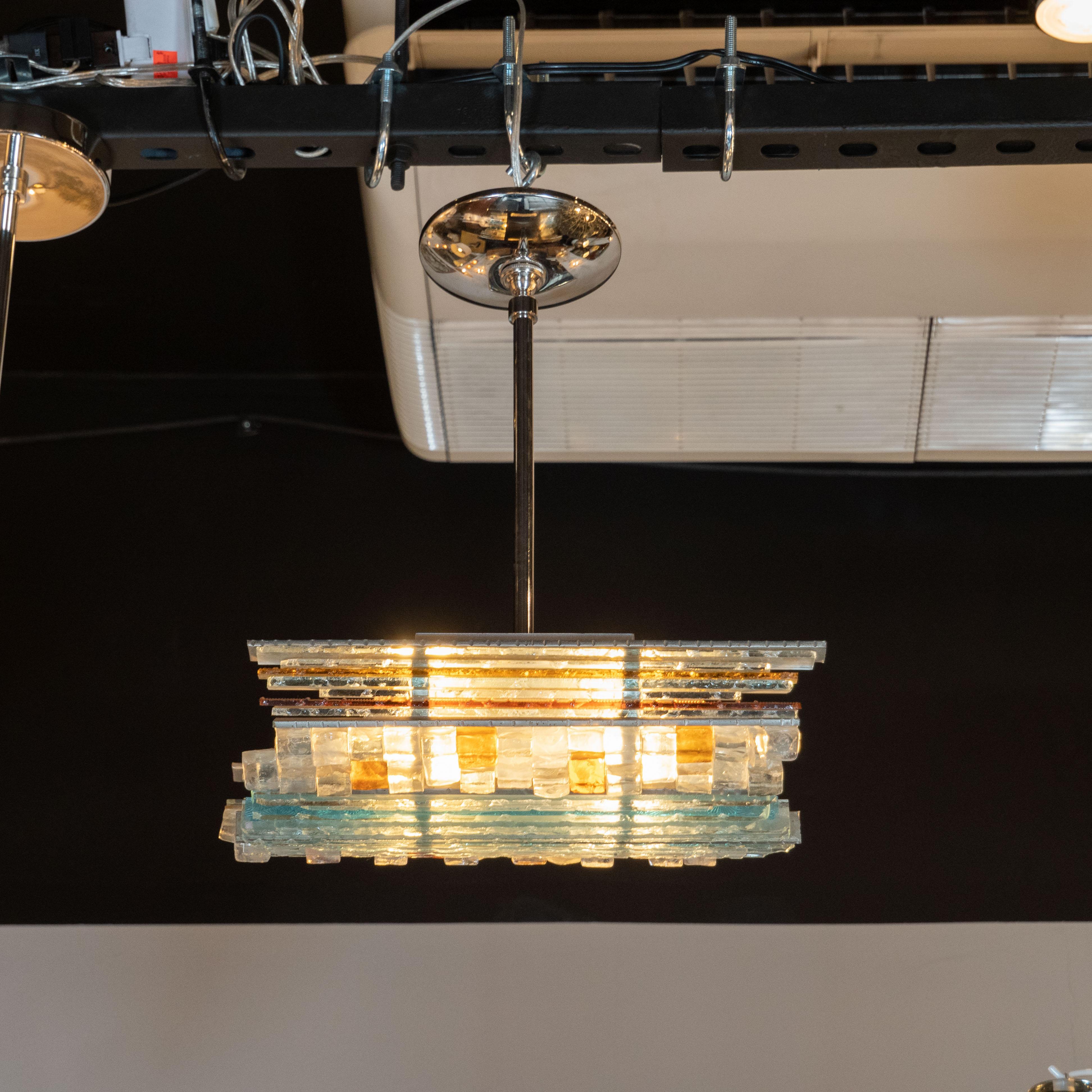 This stunning Mid-Century Modern pendant was hand blown by the renowned Italian maker, Poliarte, in Verona, circa 1970. The pendant consists of a mosaic of individual raw crystal elements- elongated strips stacked horizontally as well as cubic