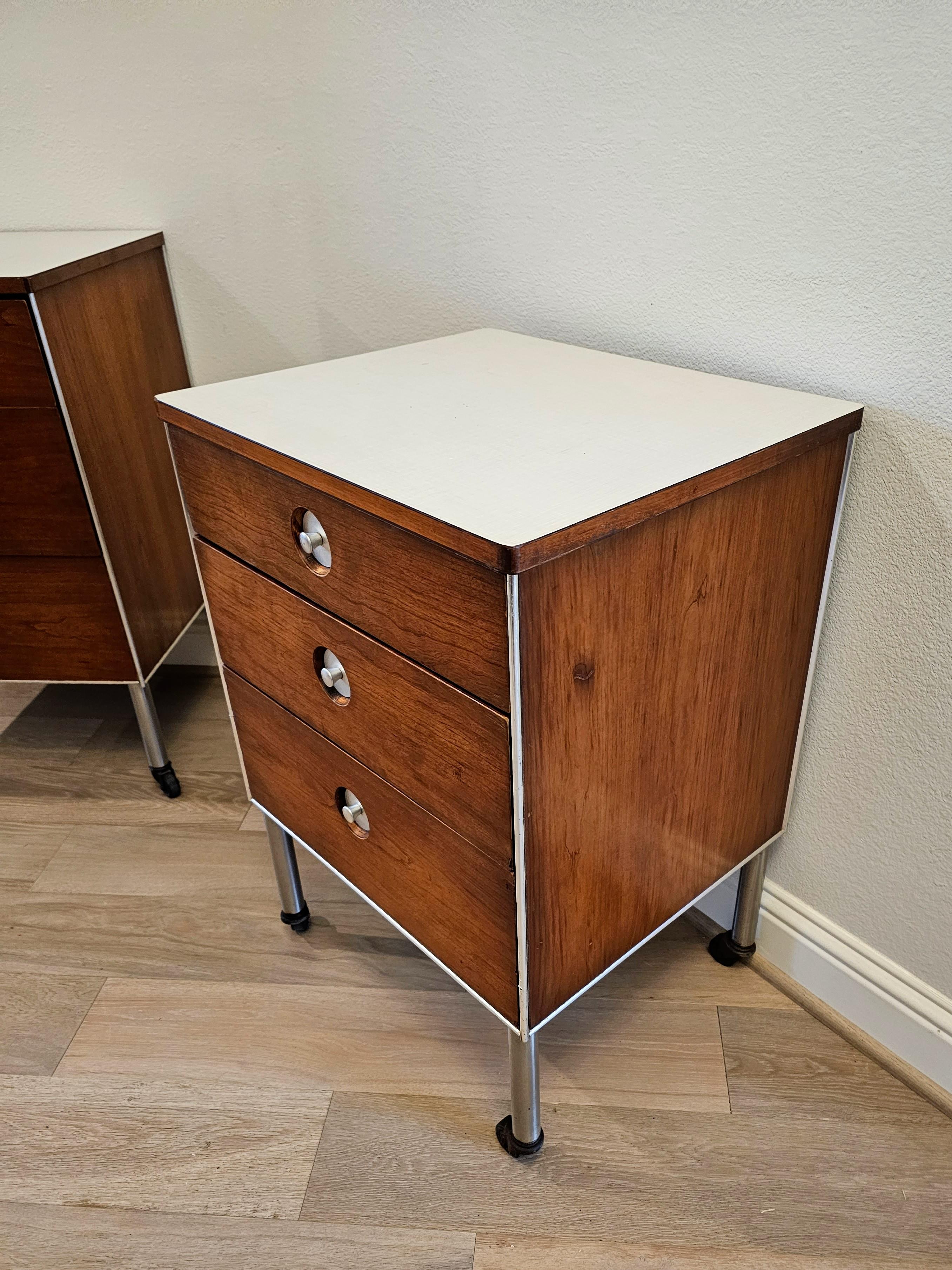 A striking pair of midcentury rolling cabinets by important Industrial designer Raymond Loewy (American, 1893-1986) for Hill Rom. 

Wonderful examples of Loewy's mixed Material work, both vintage medical carts having off-white laminate tops that