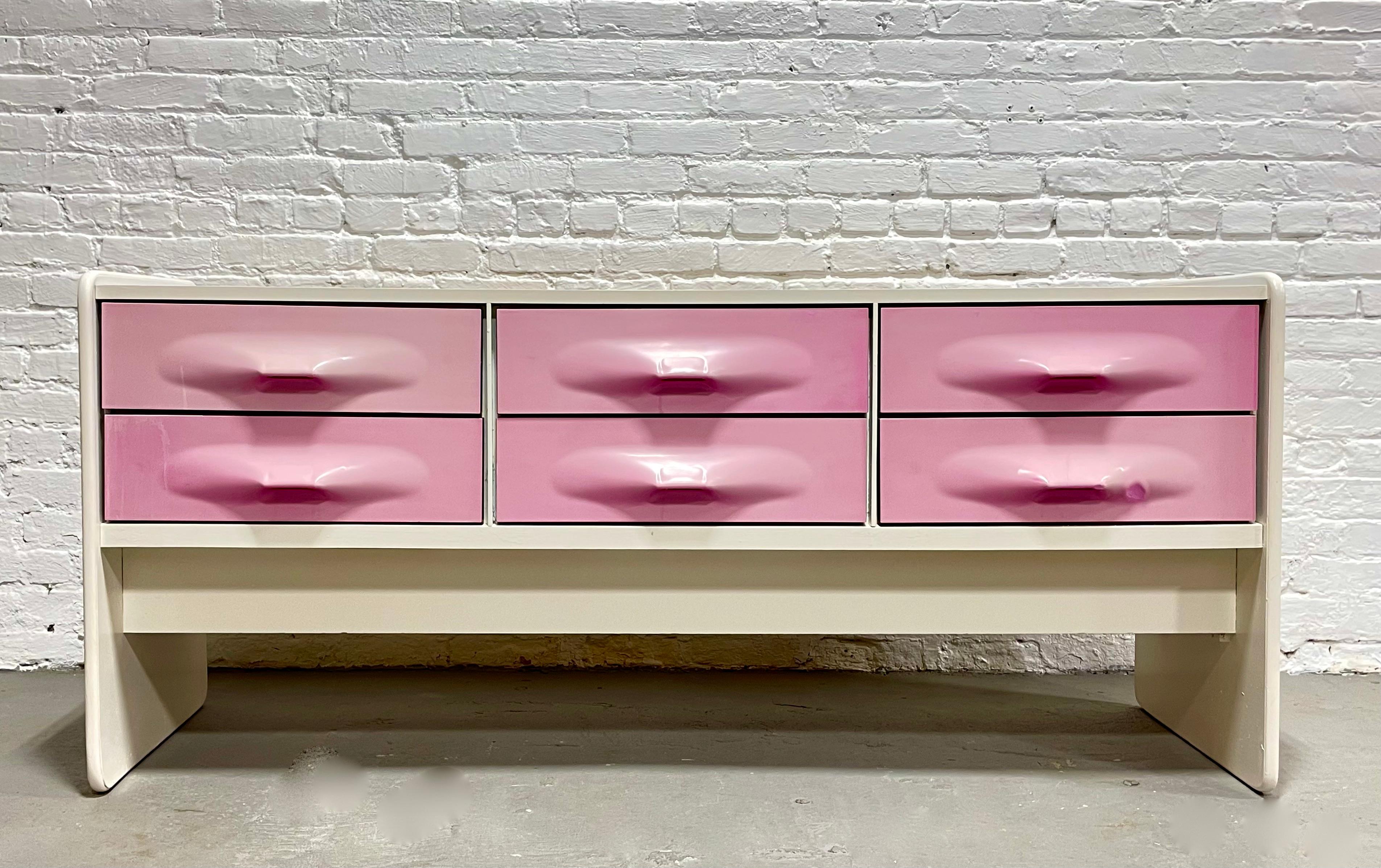 Rare Mid-Century Modern long dresser / credenza by Giovanni Maur for Treco, circa 1970, Made in Canada. This style is reminiscent of Raymond Loewy’s DF2000 series and features the less common pink ABS molded drawer fronts encased in white wood