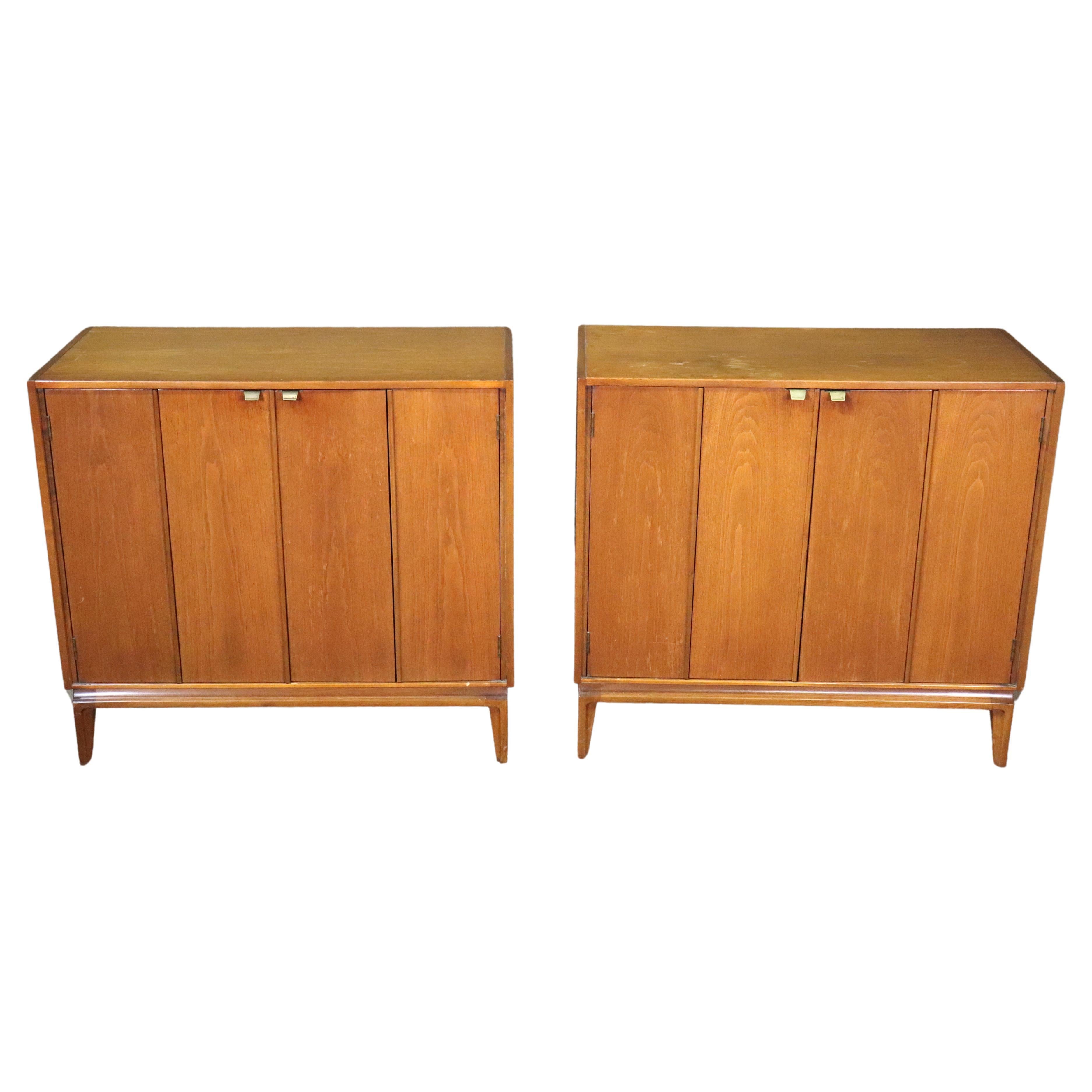 American made mid-century cabinet with bi-fold doors. Metal pulls open the doors to reveal an open cabinet with shelf. 
Listing is for one.
Please confirm location NY or NJ