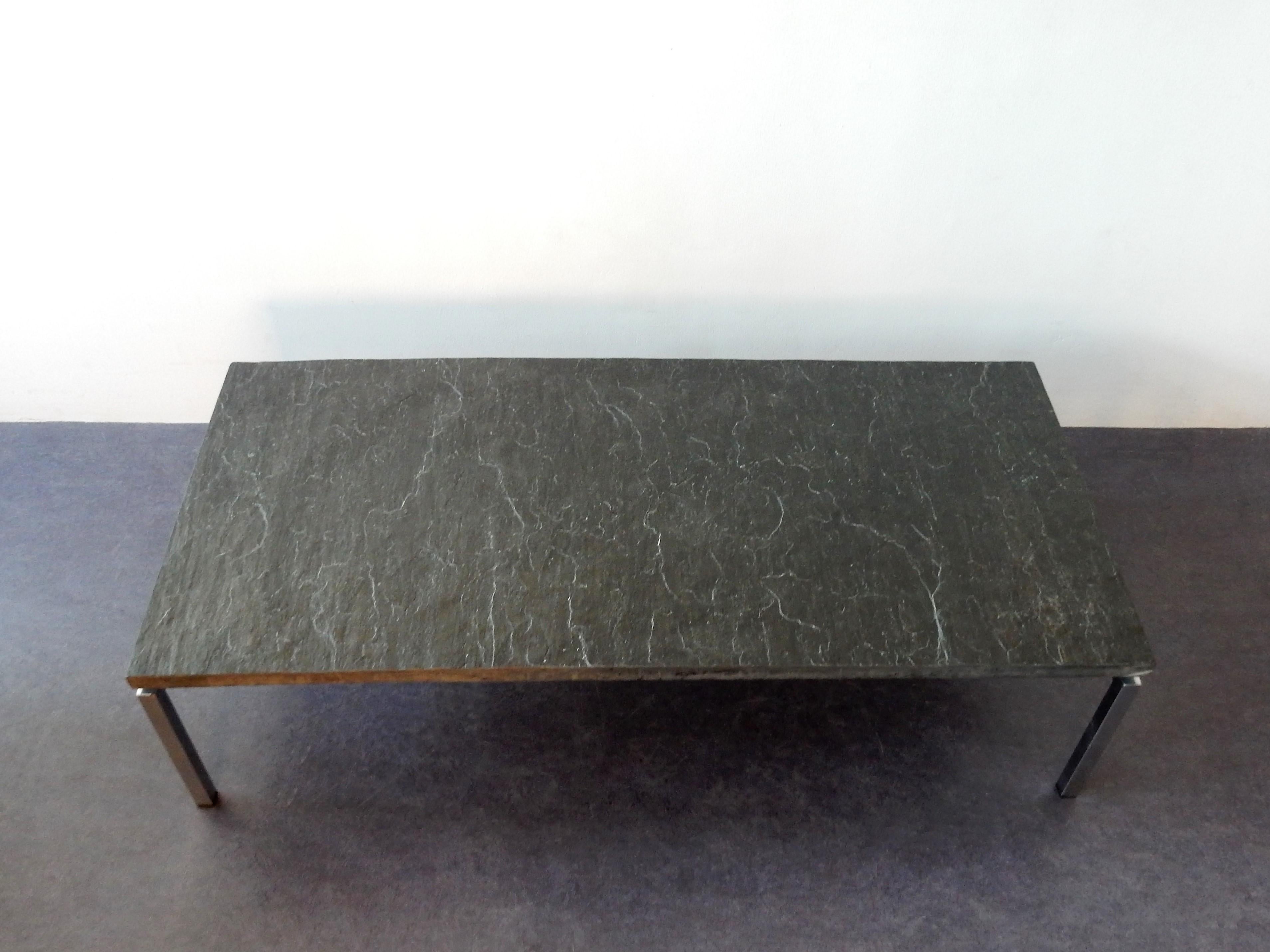 This rectangle coffee table has a heavy slate top layed down on a chromed steel welded frame. The slate top has no dents or damages. This table is in a good condition with minor signs of age and use at the frame. A good looking piece that would suit