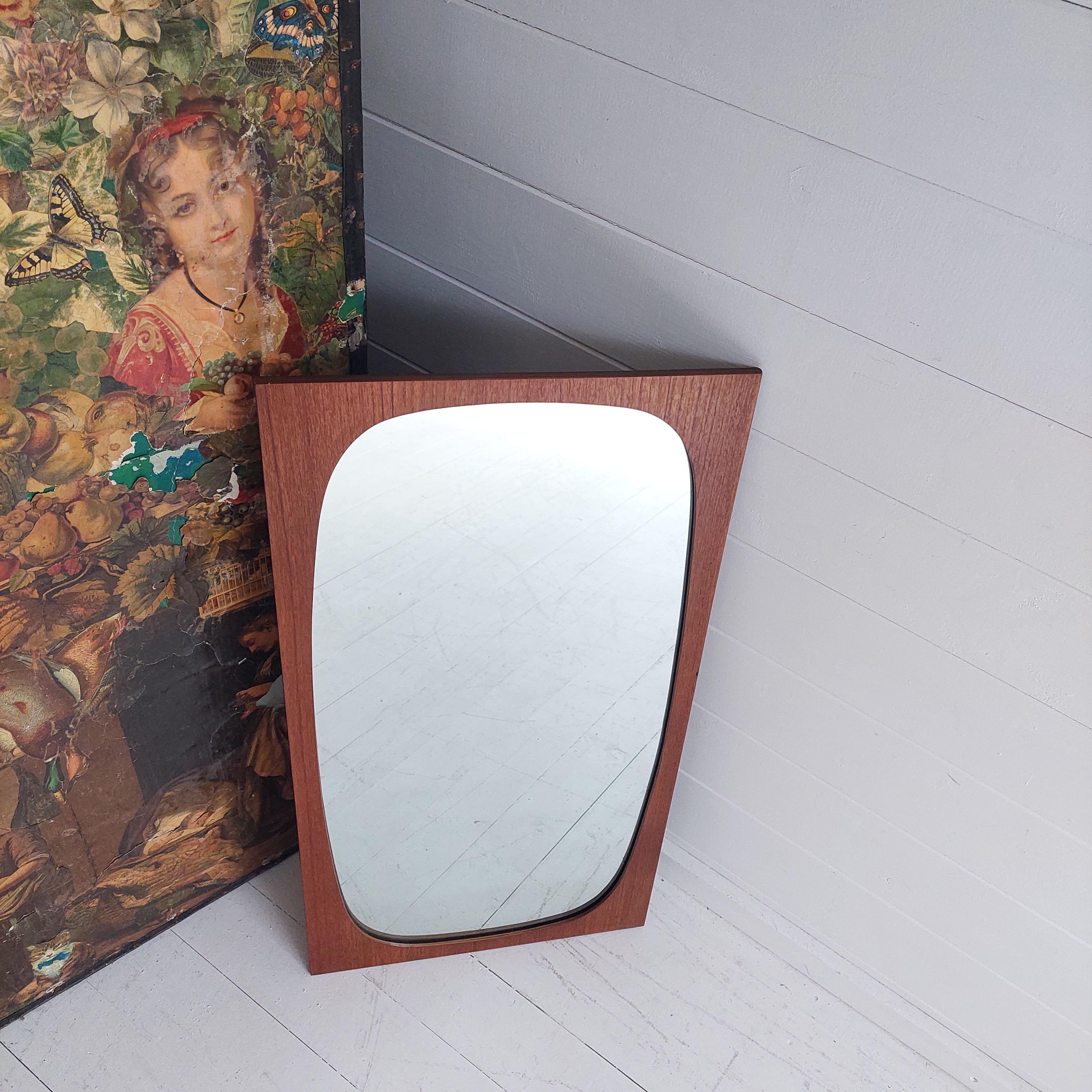This beautifully modest 1960s plywood mirror is the perfect piece to inject some retro charm to your home. 
Vintage 1960s Rectangular teak plywood framed wall mirror with inserted oval glass
The clean lines and attractive mix of shapes really give
