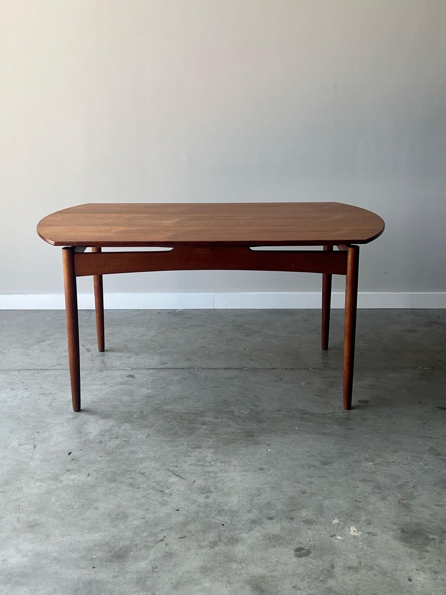 Mid-century dining table made circa 1960s by Svend Aage Madsen, Denmark. This teak dining table is beautifully made, rarely seen, and extremely unique. The tabletop transforms from a rectangle, with smooth rounded edges, into a perfect circle once