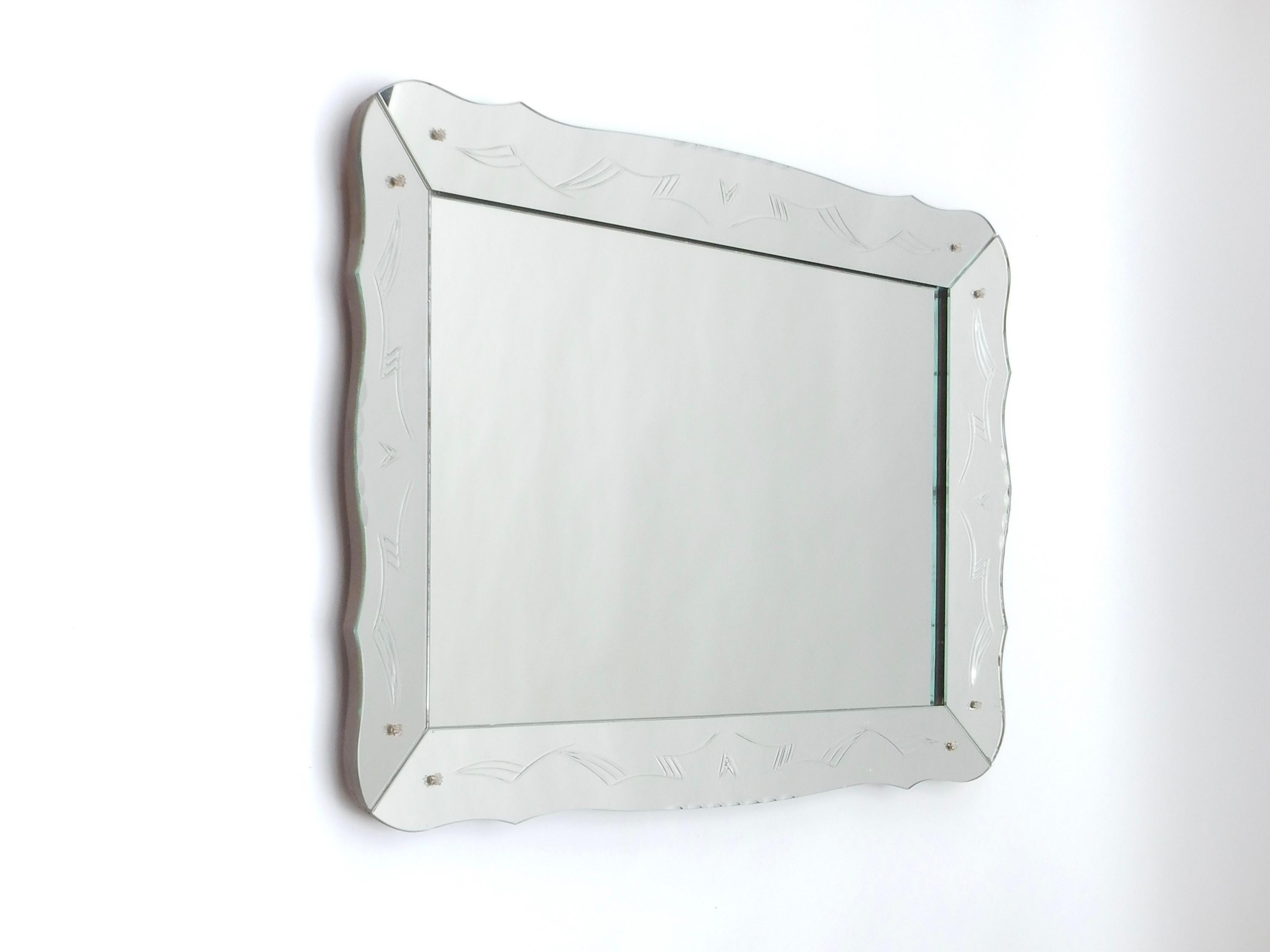 Venetian style mirror with reverse etched design. Serpentine border. Wooden back. Fine quality. May be hung vertically or horizontally. Mirror is currently prepared to hang vertically.
There is a second identical mirror which is for now available,