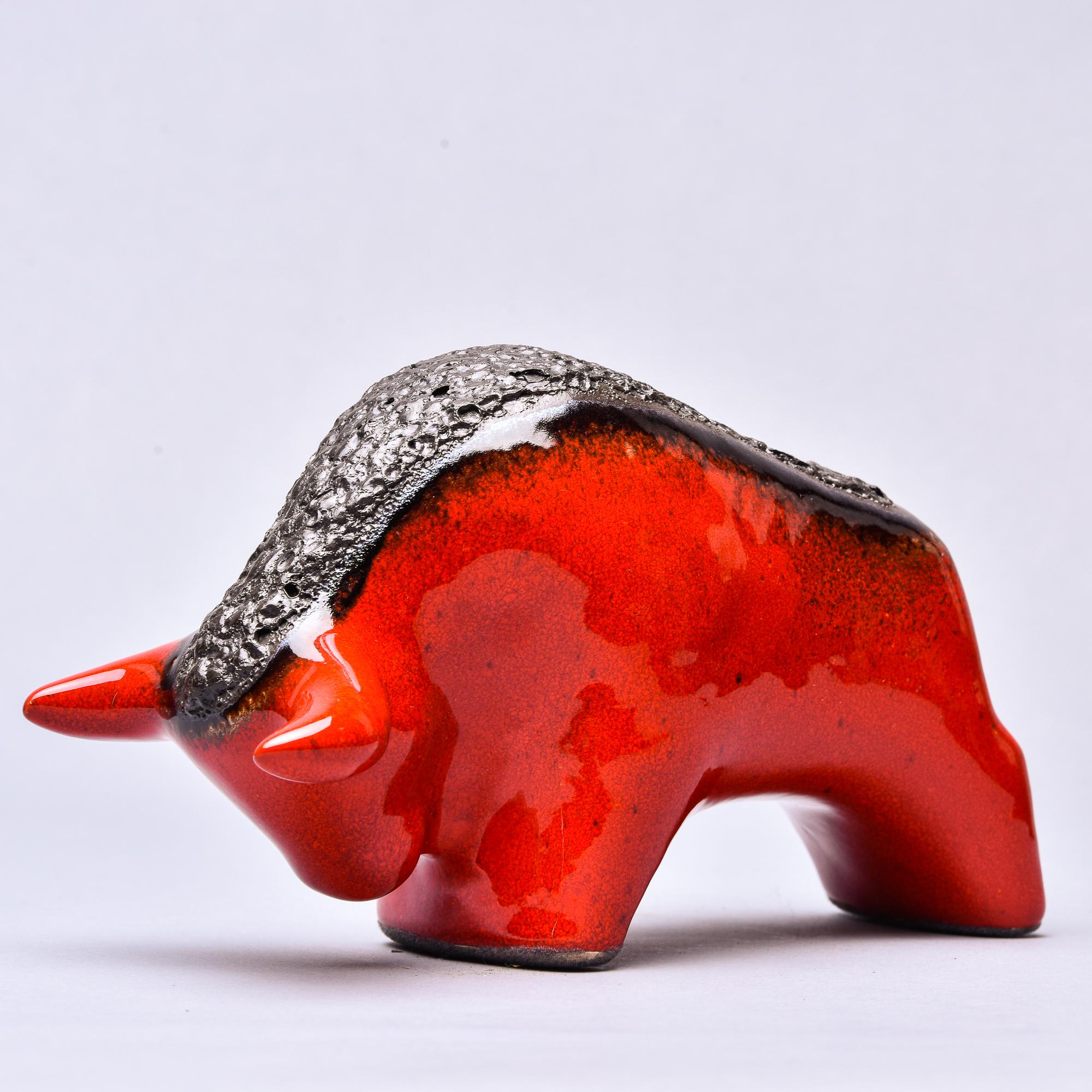 Circa 1970s lava style ceramic bull is glazed red with a wide, contrasting black lava-style strip down the center back. Unknown German maker. No flaws found.  