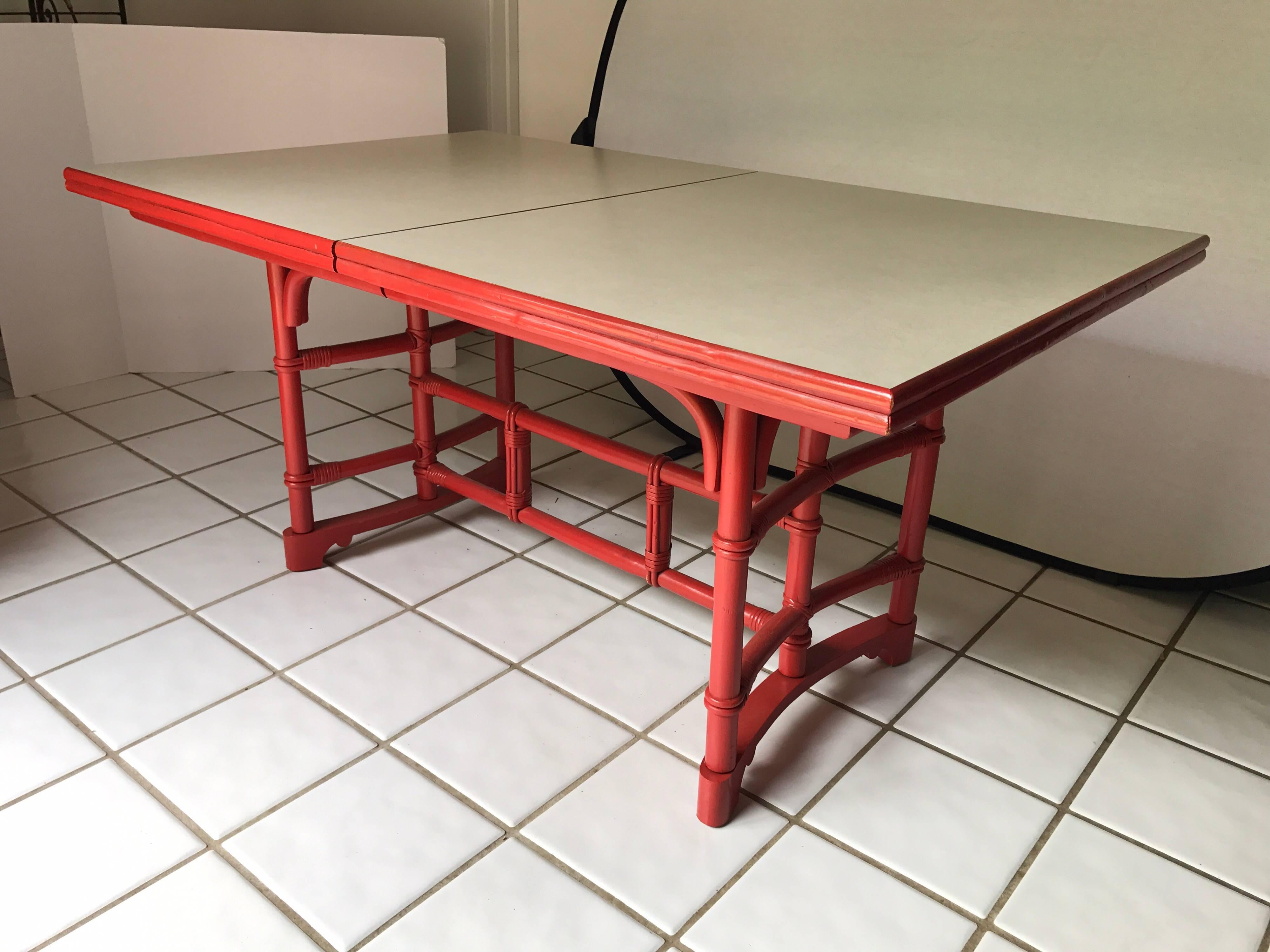 Exceptional 1970s dining set purchased through DIA and featuring six Chinese Chippendale red bamboo chairs (two-arm/four side) with original vinyl seats and matching table with white laminate top. Chair dimensions are 18 x 18 x 34 x 18 seat height.