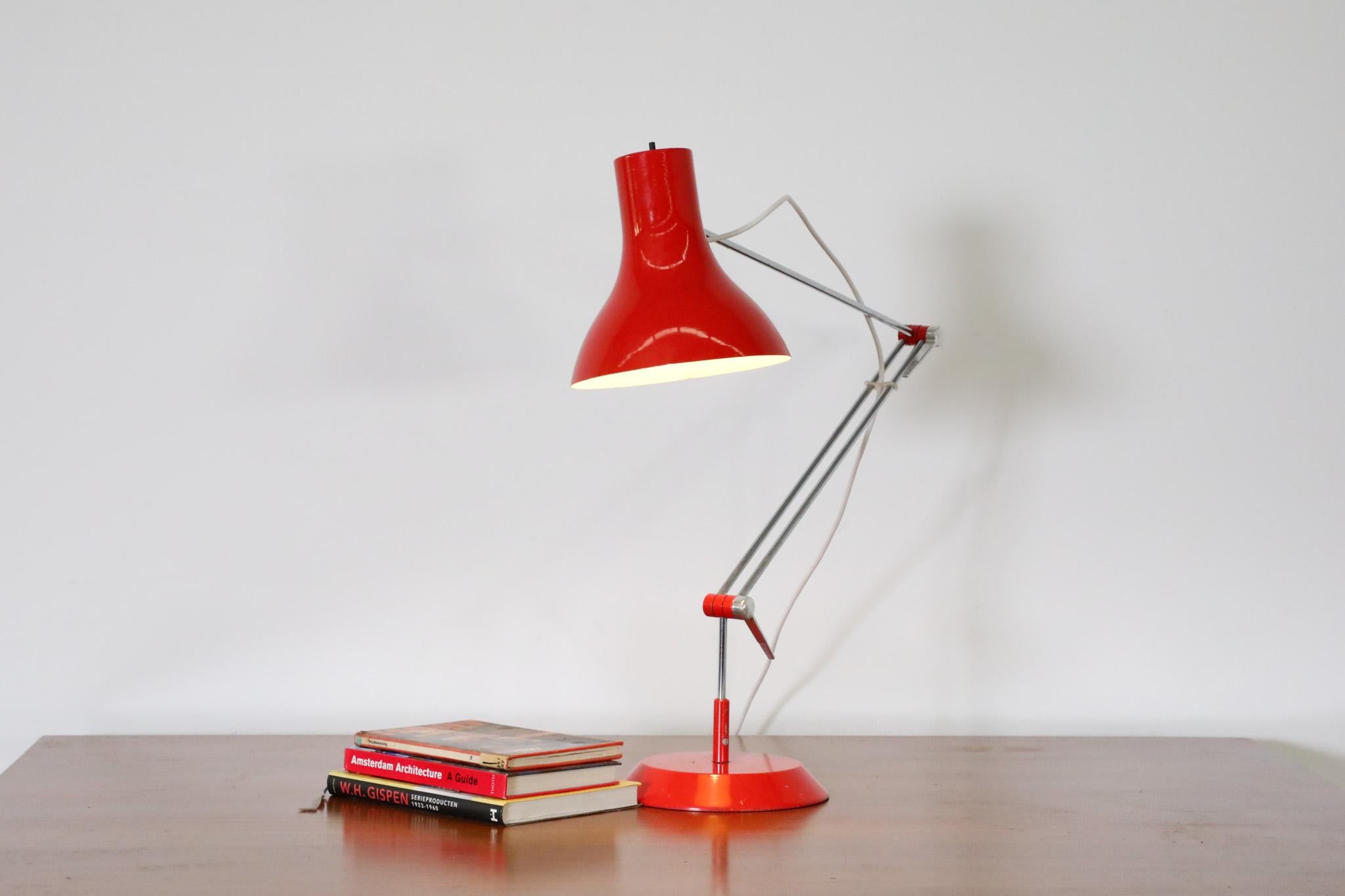 Mid-Century Industrial task lamp by Napako, 1950's. Red enameled aluminum shade on a multi-adjustable chrome stem with a heavy weighted metal base. A well dressed table lamp perfect for adding directional light to a desk or side table. In original
