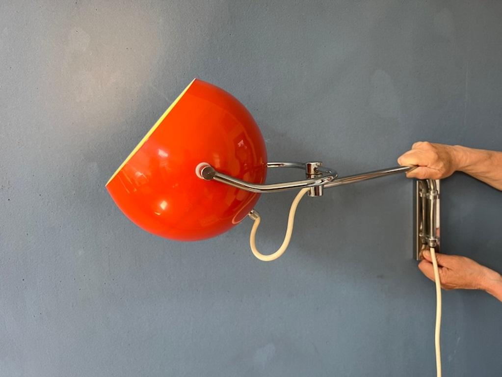 Rare red GEPO eyeball wall lamp with chrome frame. The shade can turn around its axis and its holder can be turned left and right. The lamp is easily mounted with two screws. The lamp requires an E27 (standard) lightbulb and currently has an