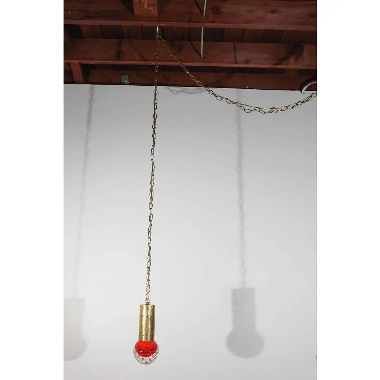 Midcentury pendant with blown glass sphere. Sphere contains controlled bubble inclusions. Fixture has a brass chain, and can be wired for either swag or hard-wired installation.