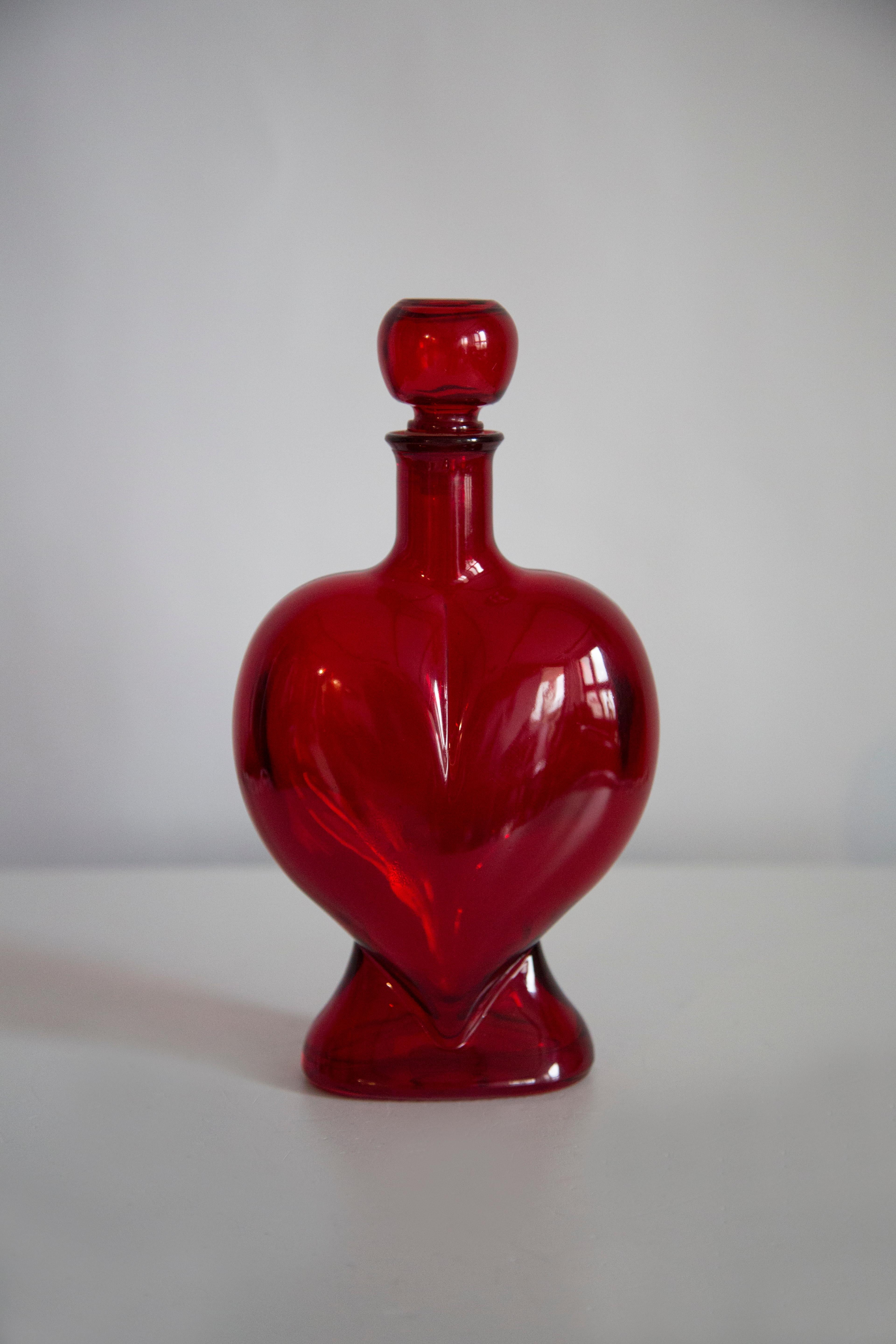 A red blue decanter with heart shape design, made by one of the many glass manufacturers in Italy. Would make a great addition to any collection! Original good vintage condition. Only one unique piece.
 