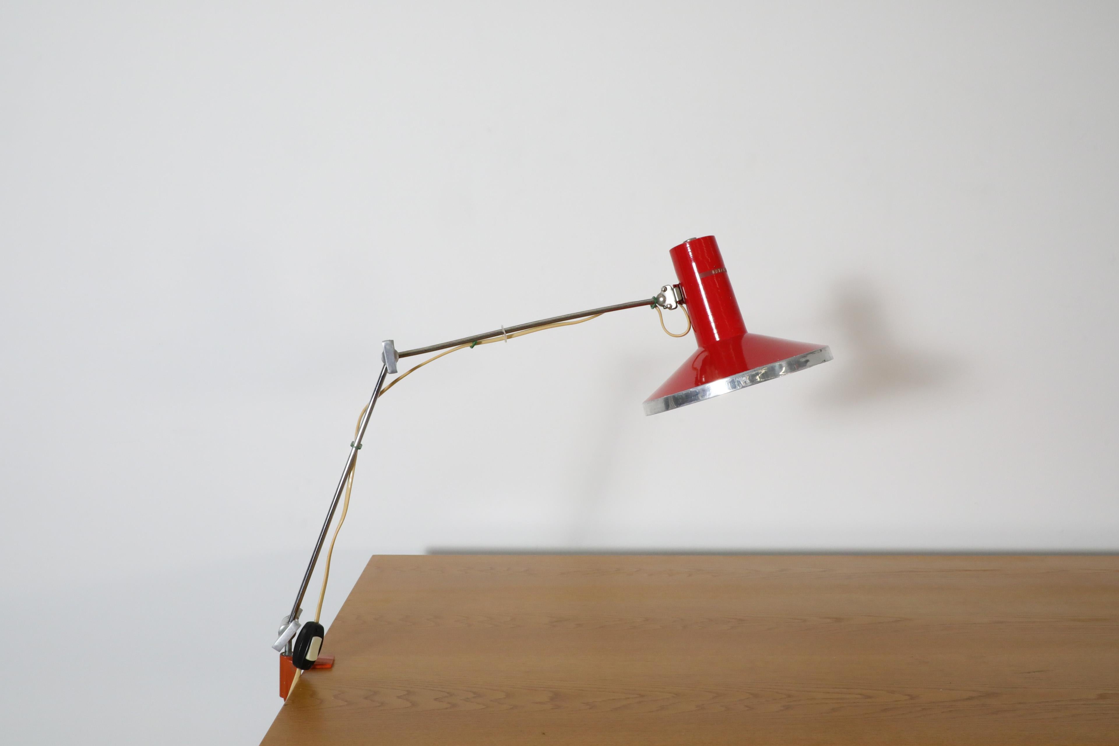 Industrial clamp on drafting lamps with red aluminum shade and chrome adjustable stem. Attributed to Napako. Vintage studio light with orange clamp that fit on any table edge up to 1.5