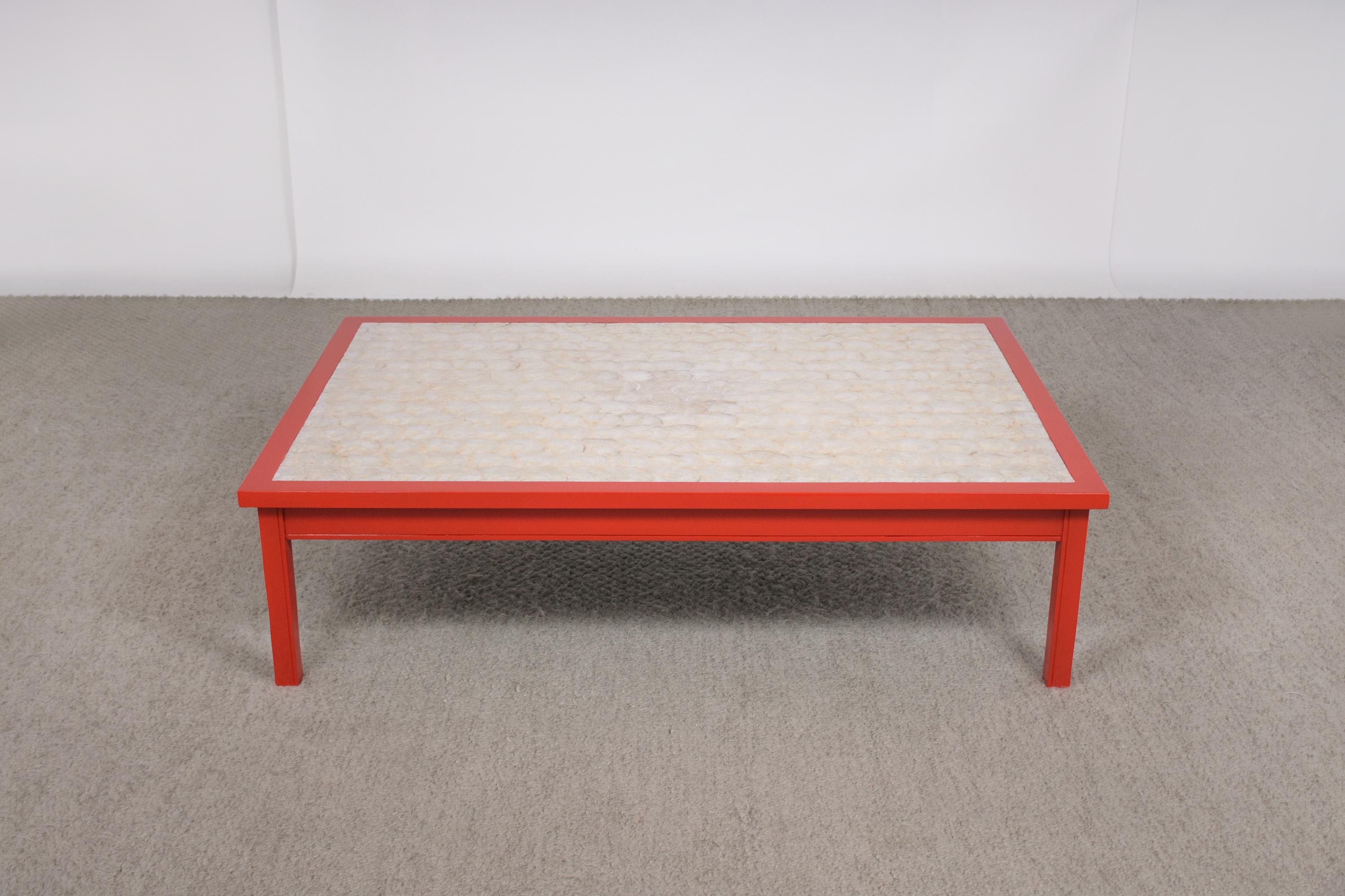 Step into the vibrant world of mid-century design with our stunning red coffee table, a piece that exudes style and history. Expertly restored by our seasoned craftsmen, this table is handcrafted from wood and revitalized to showcase its mid-century
