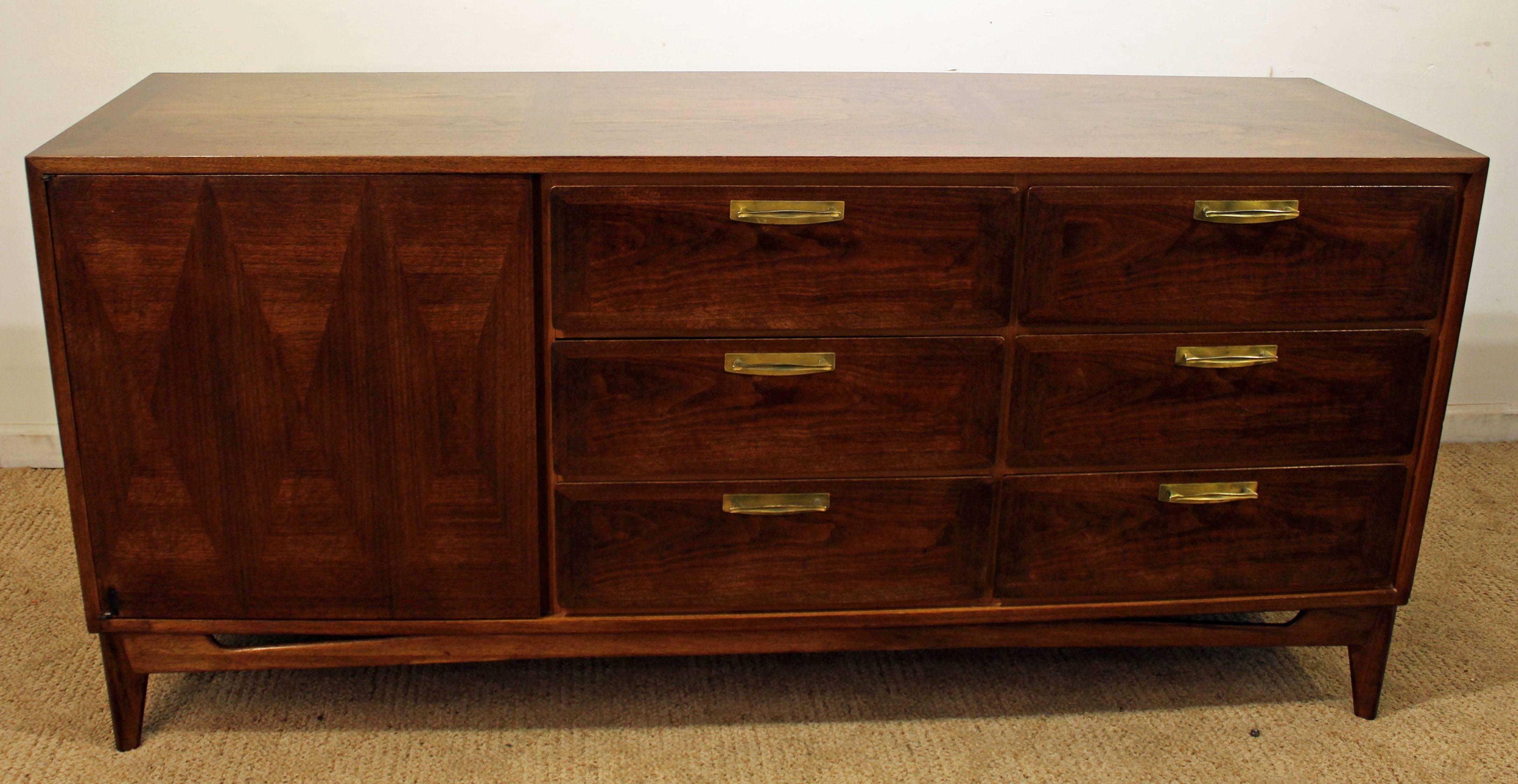 The piece is made of mahogany with a dark walnut stain and features a parqueted door with three drawers inside, plus six more drawers on the other side. It has been refinished with a dark walnut stain.

Dimensions:
68.5