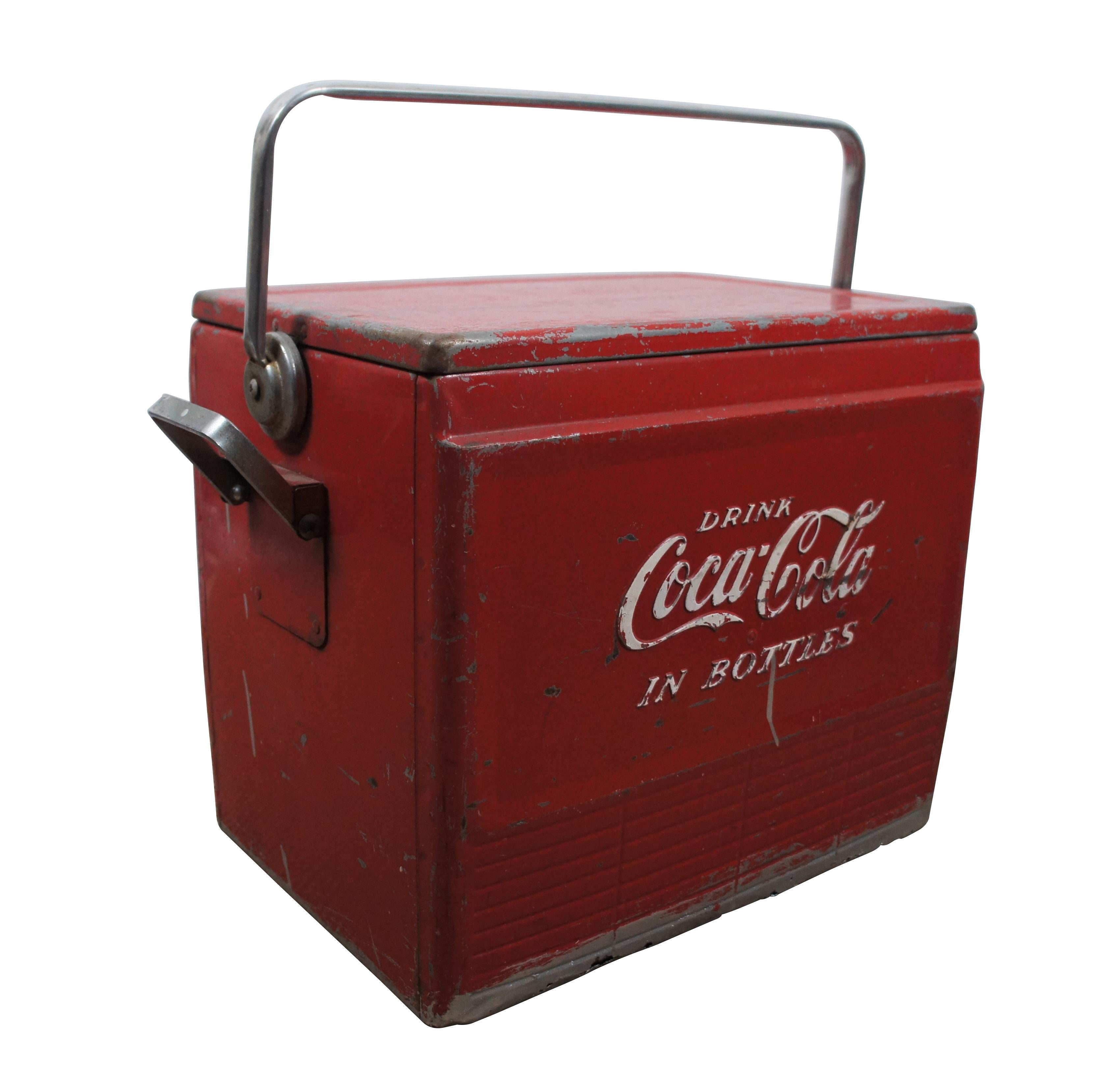 Vintage 1950s Coca Cola red metal beverage cooler featuring tray insert, drain and bottle opener.  Drink Coca Cola in Bottles.

Dimensions:
20