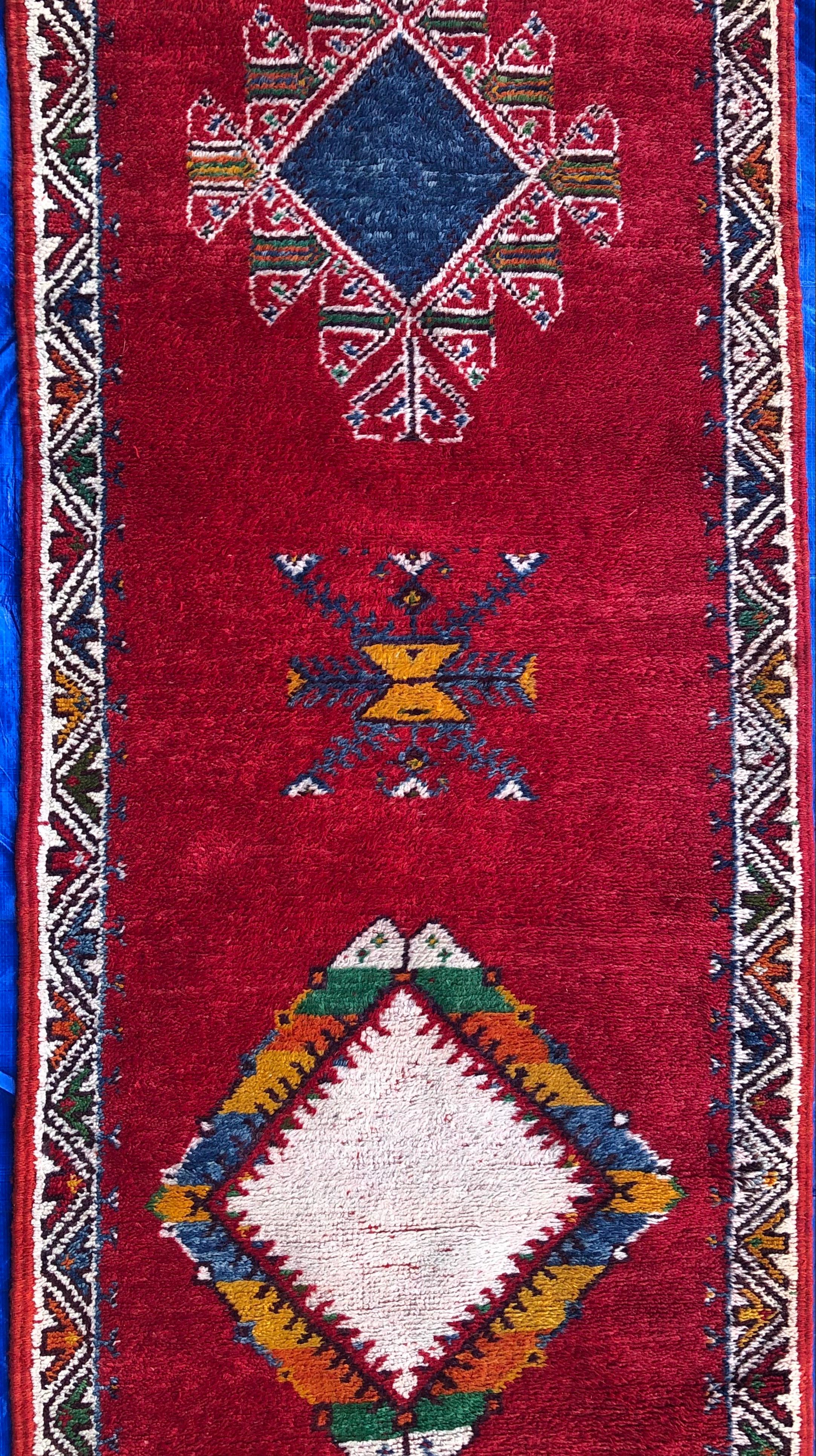 Very long Moroccan tribal carpet or runner with magnificent vivid colors and interesting motifs made by the Berber nomads. A wonderful example displaying a vibrant tribal sensibility, carpets like this also draw upon the classical weaving traditions