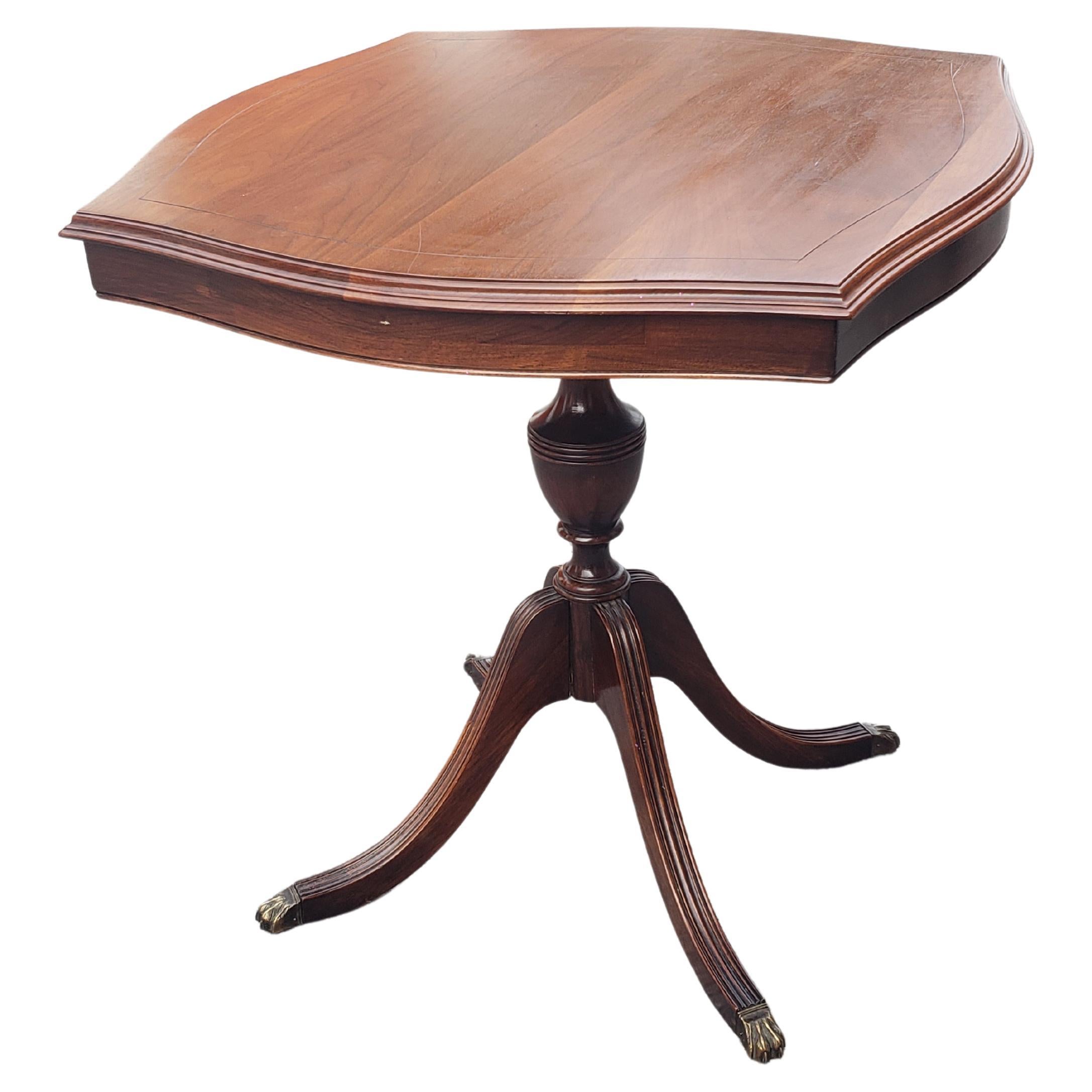 A Mid-Century Refinished Solid Walnut Pedestal Quadpod Tea Table with Brass Paw Feet. Measures 27.5