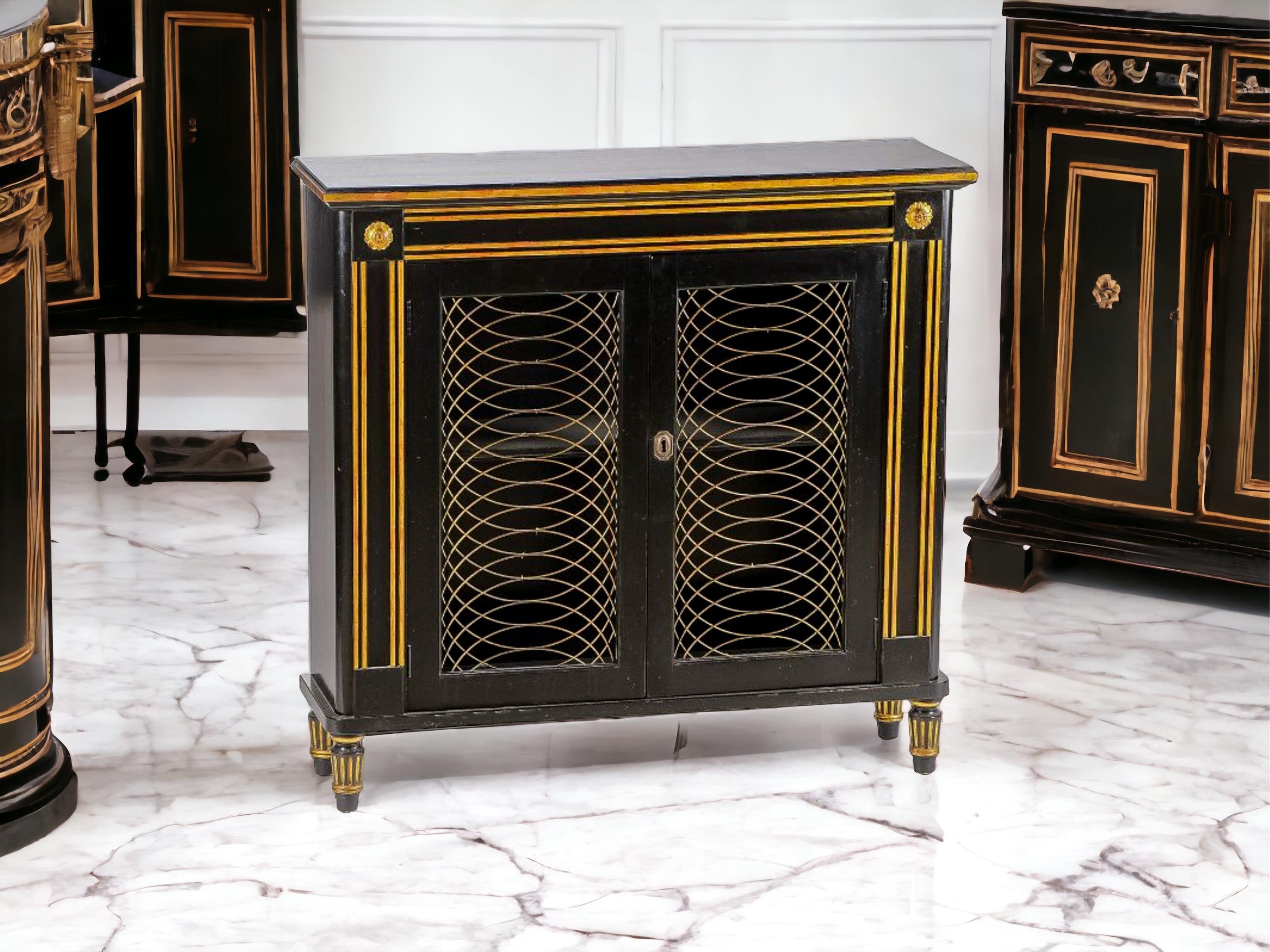 This is a mid-century Regency style Italian cabinet with a painted black lacquer finish and gilt accents. It opens to a single shelf. Note the raised panels and and turned feet! It is unmarked and in very good condition. Perfect for a bathroom!

My