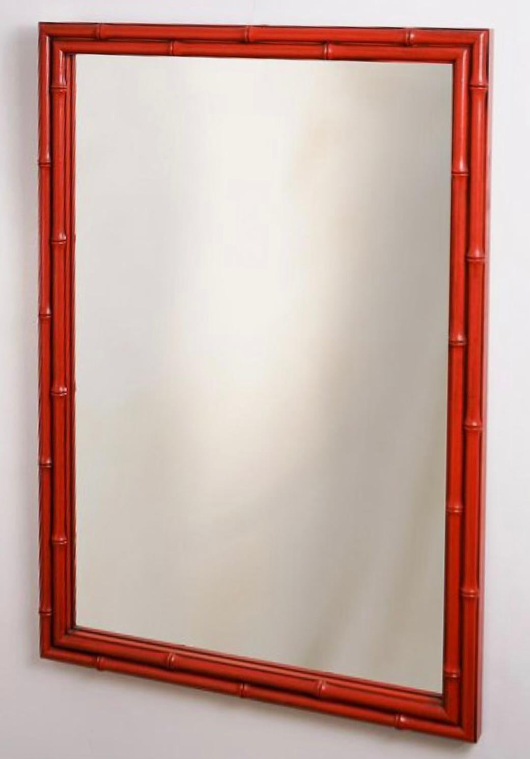 This is a nice looking wall accent. It is a mid-century Regency style carved wood Chinese red carved wood faux bamboo mirror. It is unmarked and in very good condition. 