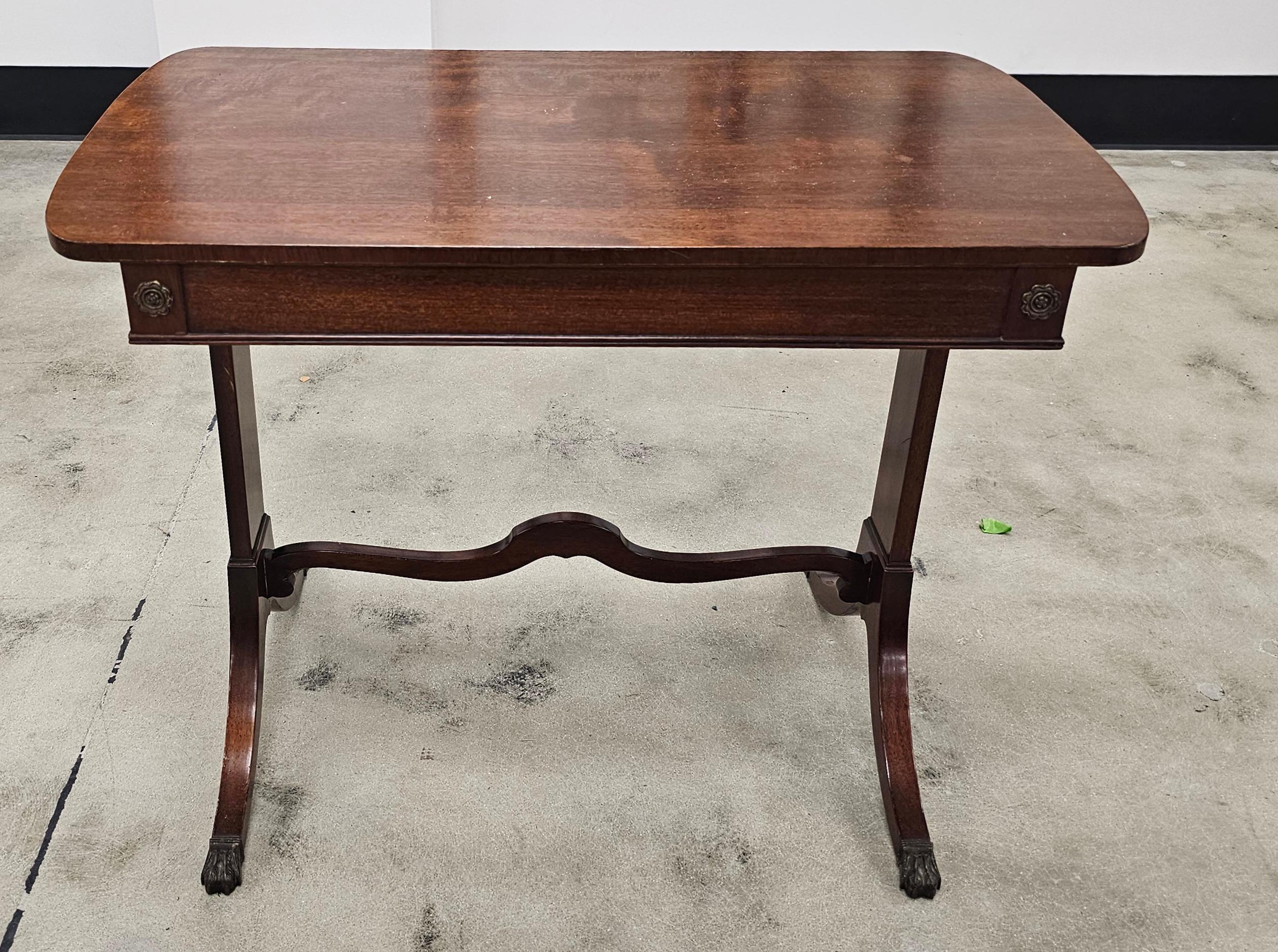 A Mid Century Regency Style Mahogany Trestle Table With Two Pull-Out Trays and Brass Cap Paw Feet
Measures 40