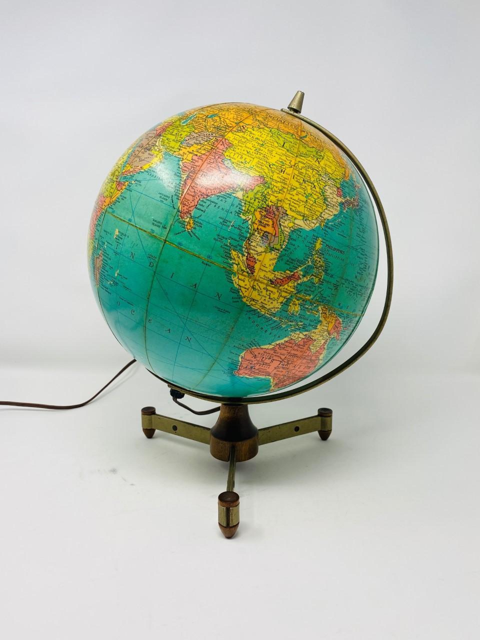 Midcentury fiberglass and wood earth globe lamp with wood and metal base by Reploge Globes Inc. Chicago.  Incredibly mod piece that stands on a metal and wood base with 3 feet.  The feet are molded teak that attach to metal legs that meet into a