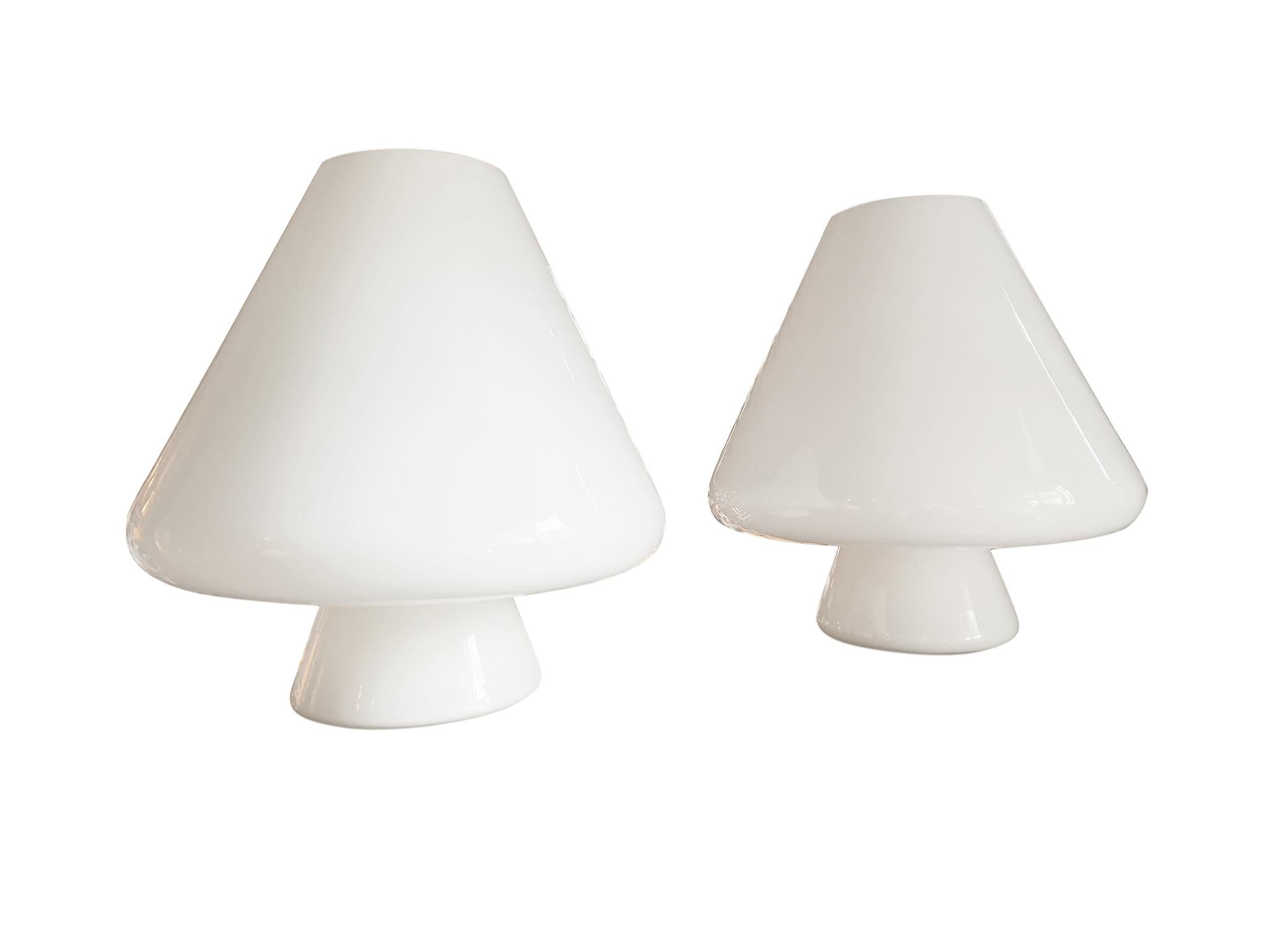 An exquisite pair of white Murano glass table lamps, remarkable for their craftsmanship and originality. hand blown in Italy, 1960s. Manufactured by Res Murano. The lamps are whimsically designed with a stout mushroom shape with coned tops and