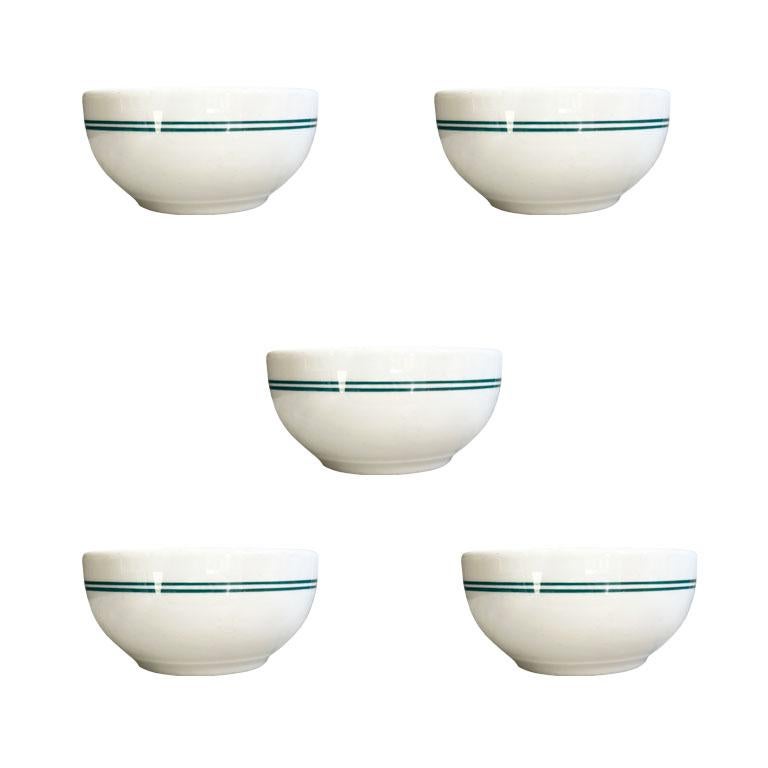 A set of five heavy restaurant ware bowls in green and white. Vintage restaurant ware is making a comeback in entertaining. Known for their strength and versatility, they seem to last forever. This set is from Shenango China, a well-known maker of