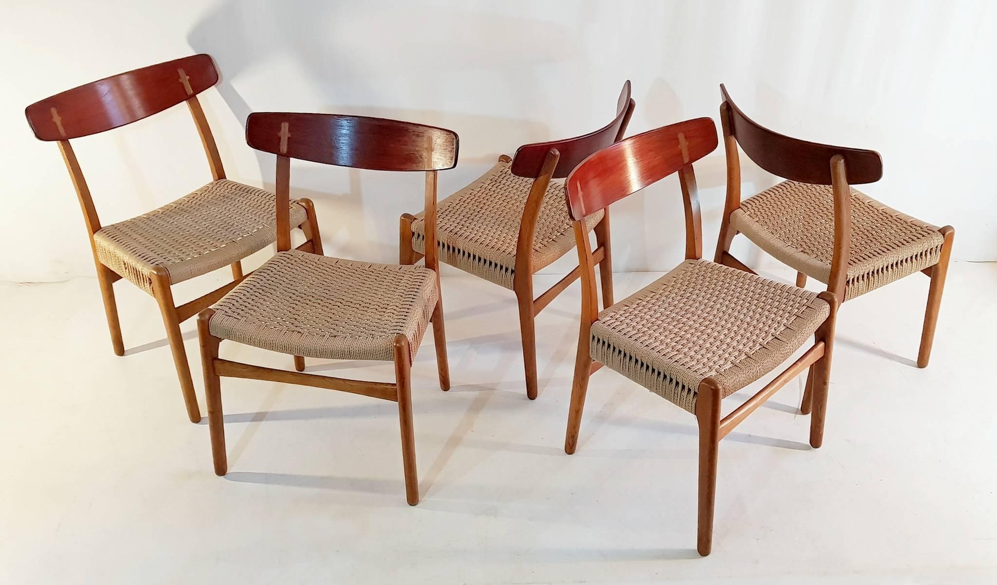 This is an early set of five Hans Wegner model CH23 oak dining chairs produced by Carl Hansen & Son in Odense, Denmark. All chairs are marked underneath the seat stating designer and producer clearly. The chairs has been fully restored including new