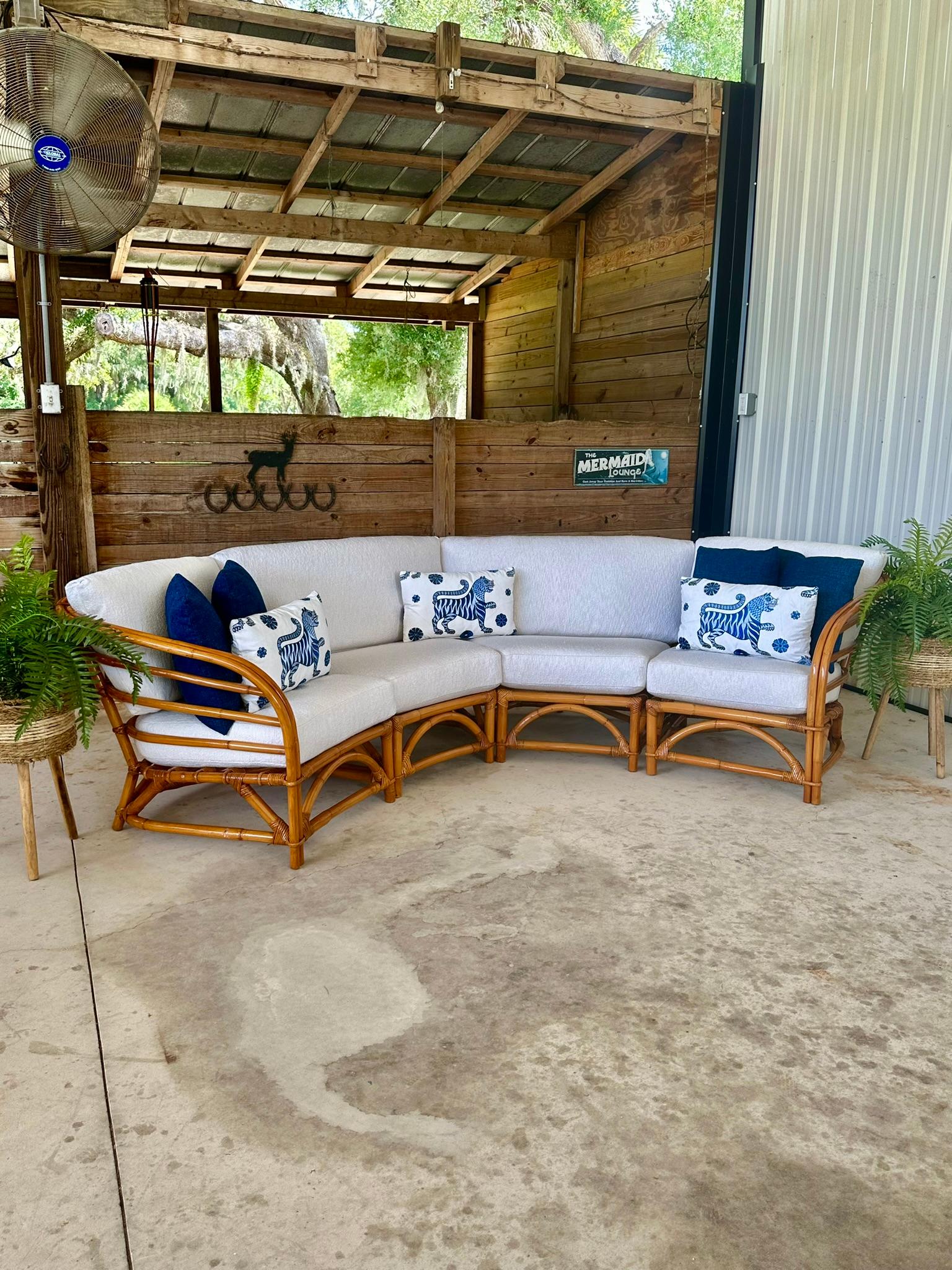 Experience the perfect blend of Old Florida charm and Chinoiserie elegance with this meticulously restored Mid-20th Century rattan sectional. This four-piece set features custom textured upholstery by Sunbrella, offering vintage appeal with modern