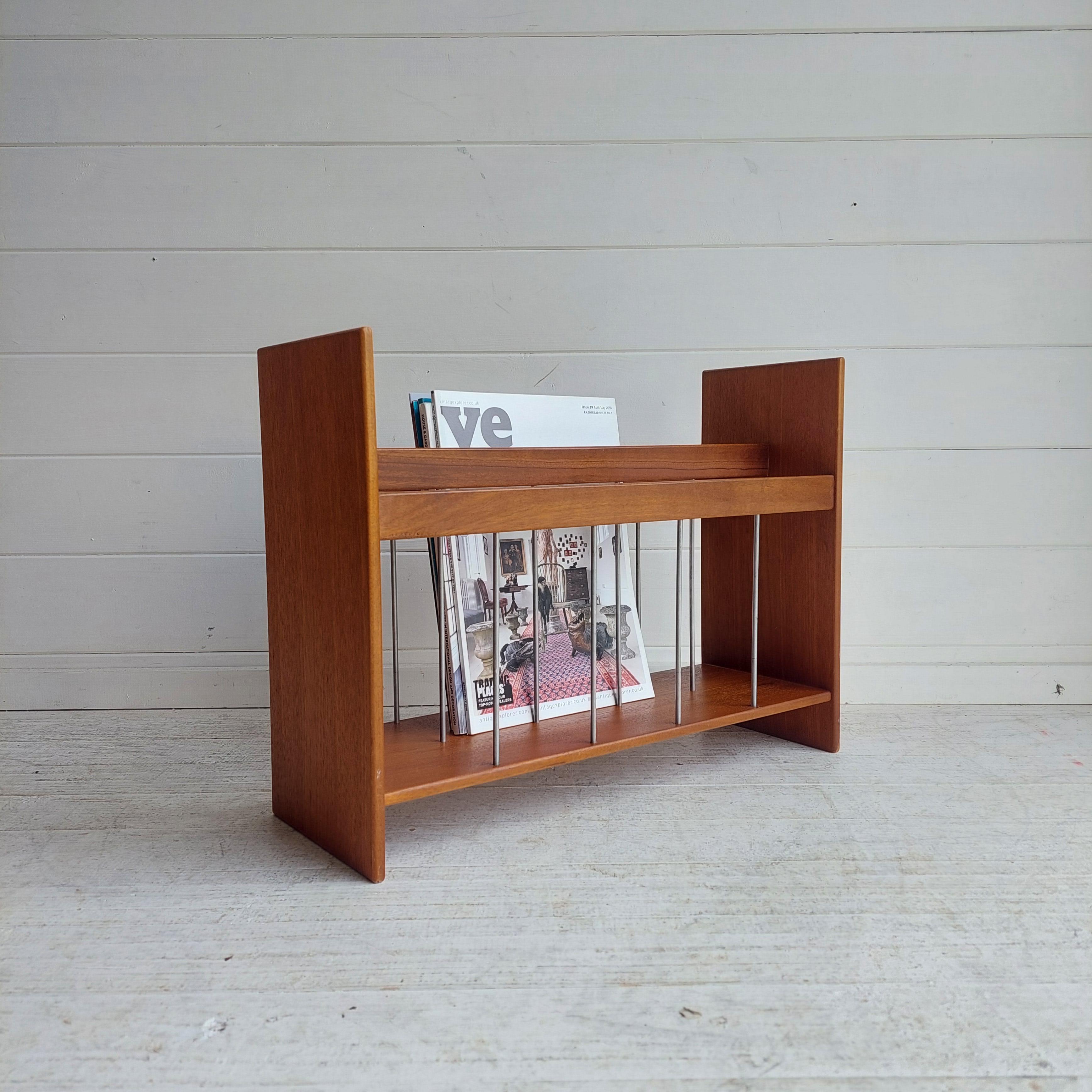 Stunning 1960s teak, Danish magazine rack.
A minimalist design, constructed of teak wood with metal supports. 
Would suit both vintage inspired and contemporary interiors. 
Manufactured in Denmark, circa 1960's.

A lovely quality solid teak magazine