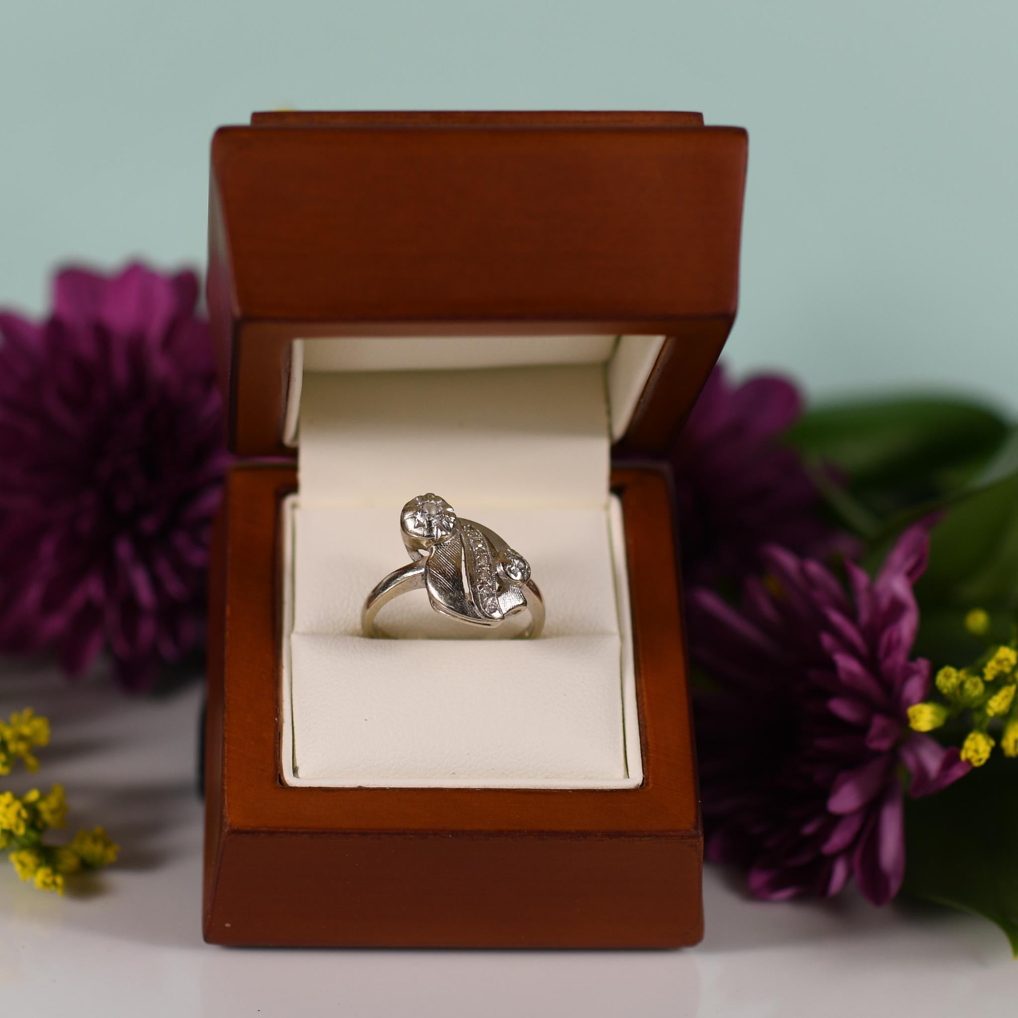 Evoke the timeless elegance of the mid-century era with this exquisite leaf-like diamond ring, crafted in lustrous 14k white gold. Inspired by the natural beauty of foliage, the intricate design features delicate diamond-encrusted leaves, each