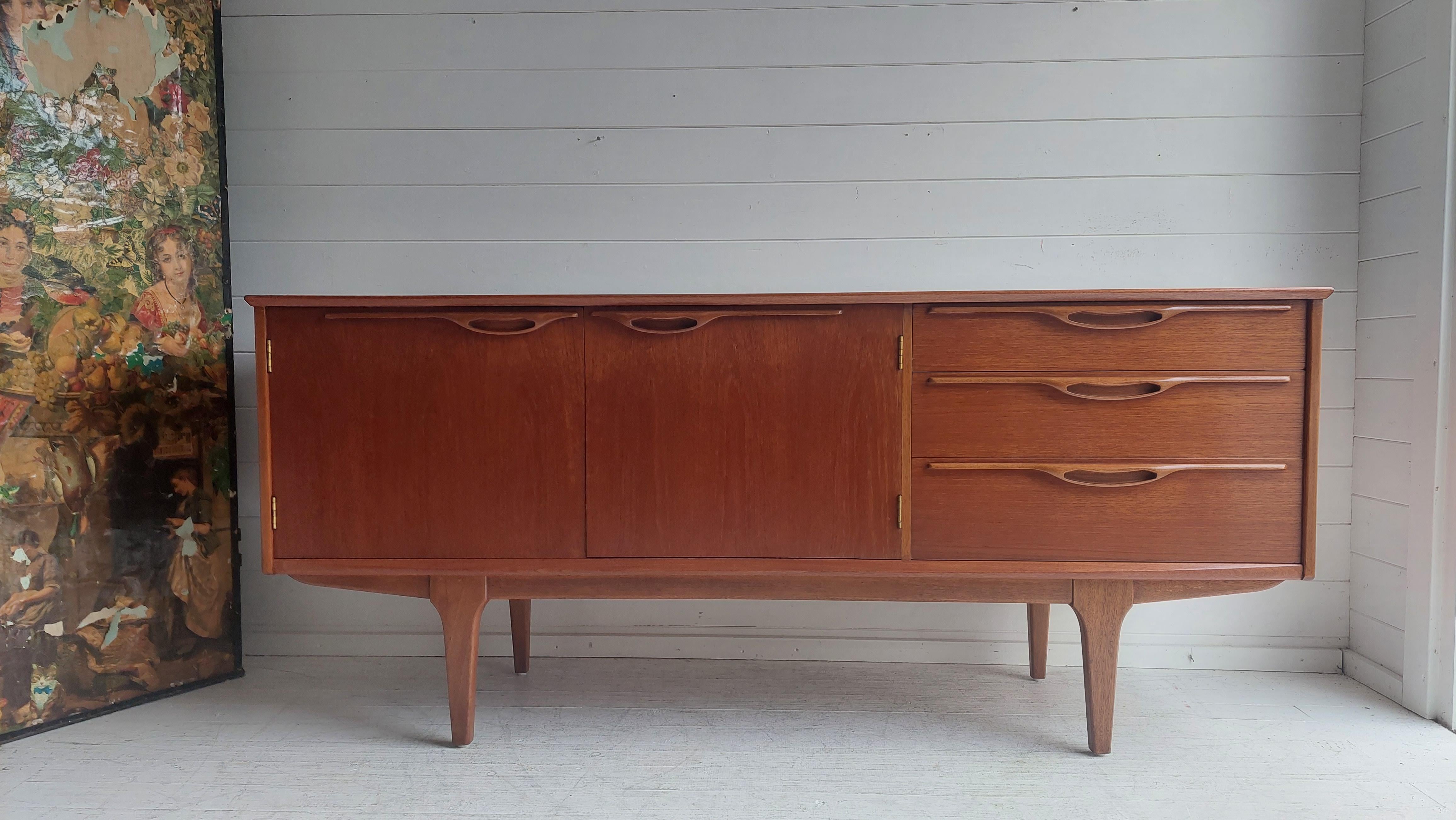 Sideboard produced in the 1960s in the British Jentique manufacture. 
Model 