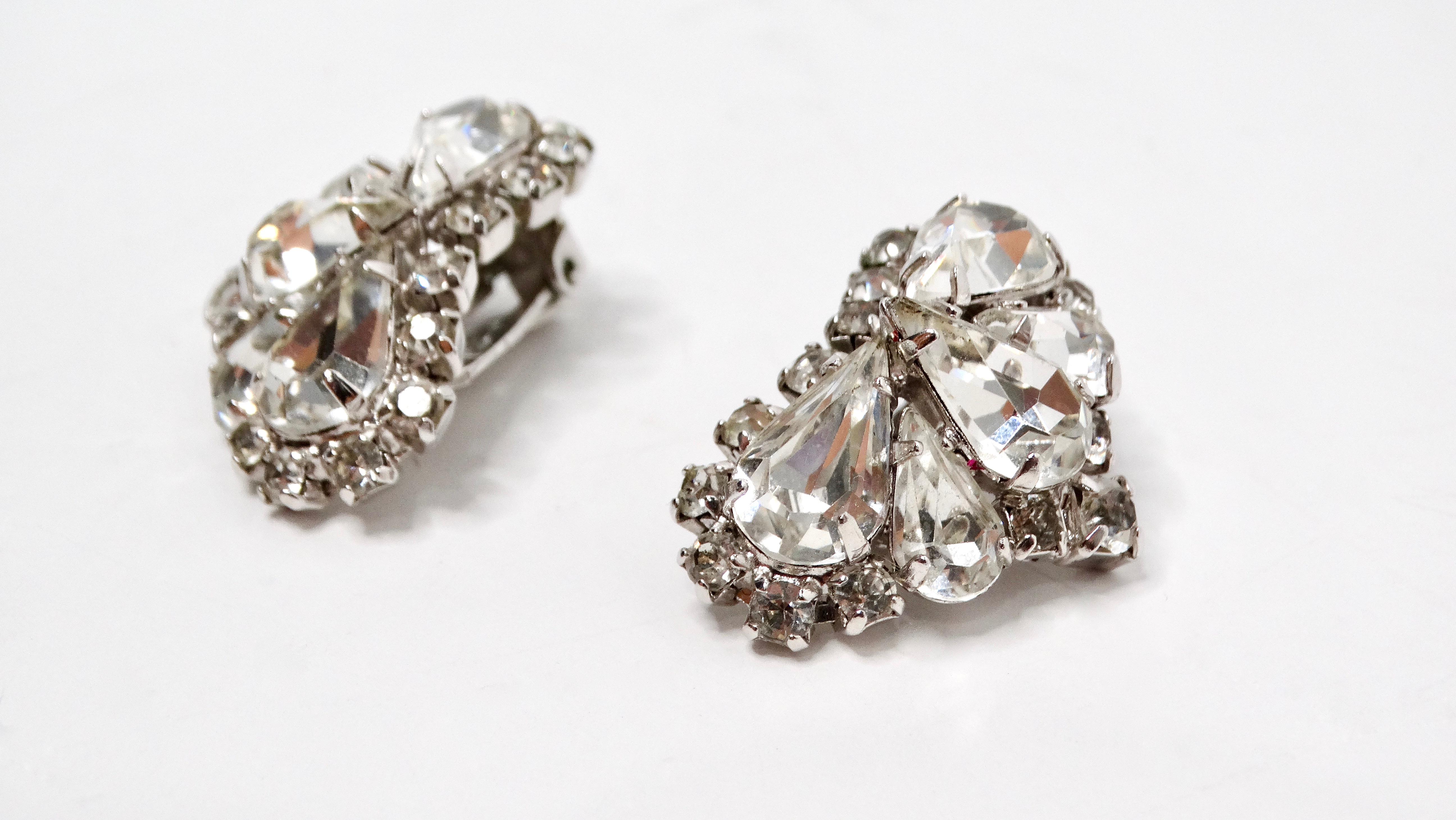Embrace the elegance of the past with these stunning Mid Century Rhinestone Sterling Silver Plated Ear Climber Clip-On Earrings. Featuring a unique ear-climber design, these earrings showcase a cascading arrangement of sparkling rhinestones that
